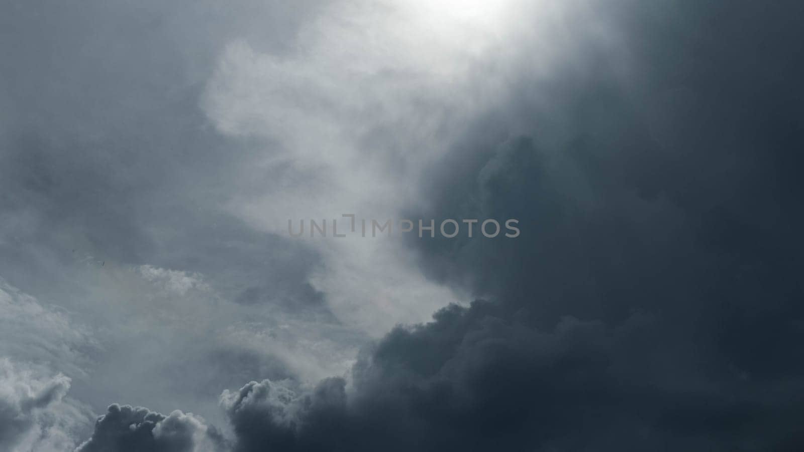 Black and white tones of the sky on a rainy day. Aerial view of the sky and black clouds. Dark grey storm clouds. Dramatic sky before the storm. by TEERASAK