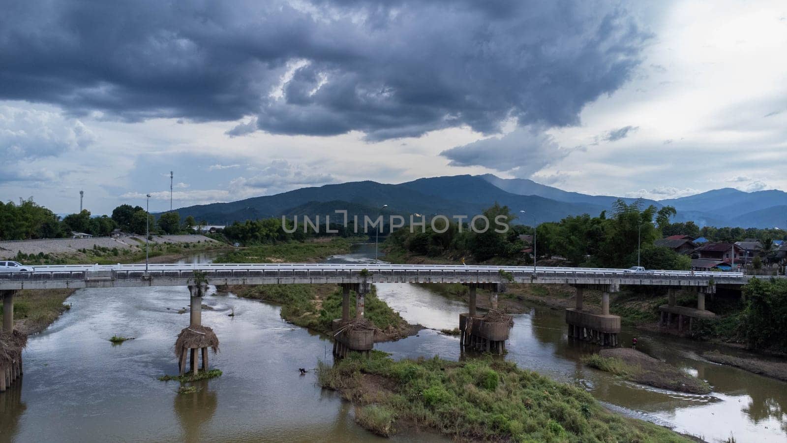 Chiang Mai (Thailand), The Bridge over the Ping River. Aerial view of the traffic on the bridge over the river. by TEERASAK