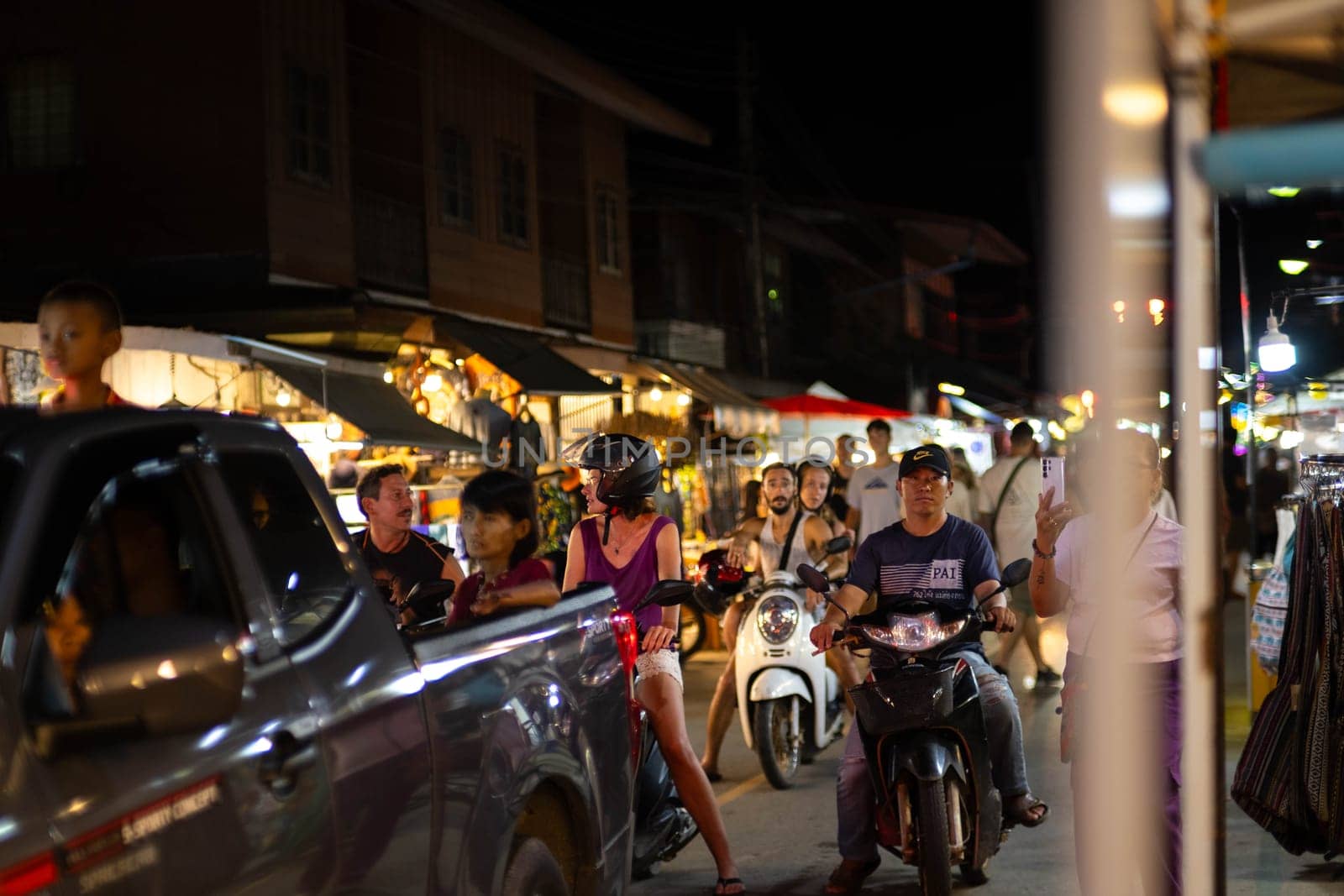 Night Market in Pai, nothern Thailand. Pai walking street market, is a food and craft market that operates every night. by TEERASAK