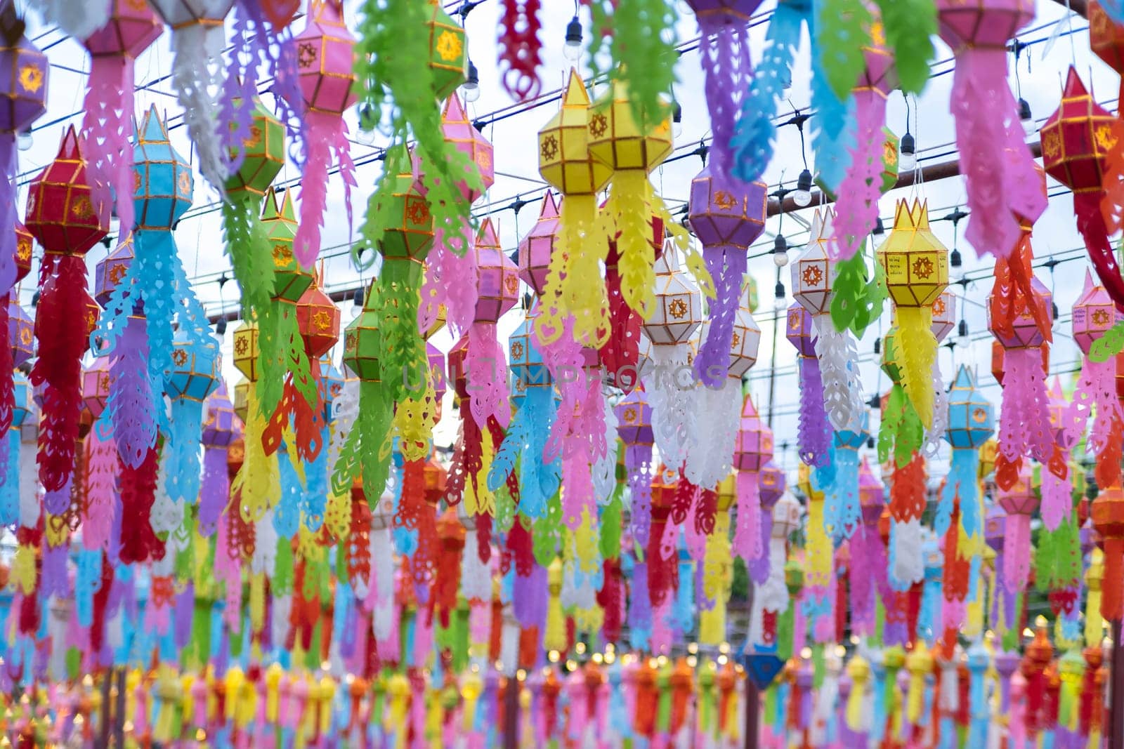Colorful Lanna paper lanterns hang in Lamphun temples. Popular lantern festival during Loy Krathong in northern Thailand. Traditional Yi Peng paper lantern.