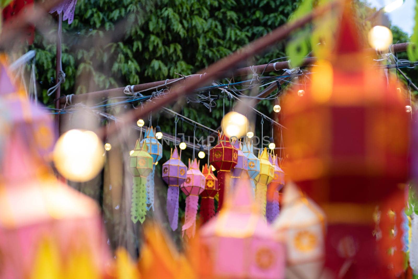 Colorful Lanna paper lanterns hang in Lamphun temples. Popular lantern festival during Loy Krathong in northern Thailand. Traditional Yi Peng paper lantern. The Hundred Thousand Lantern Festival. by TEERASAK