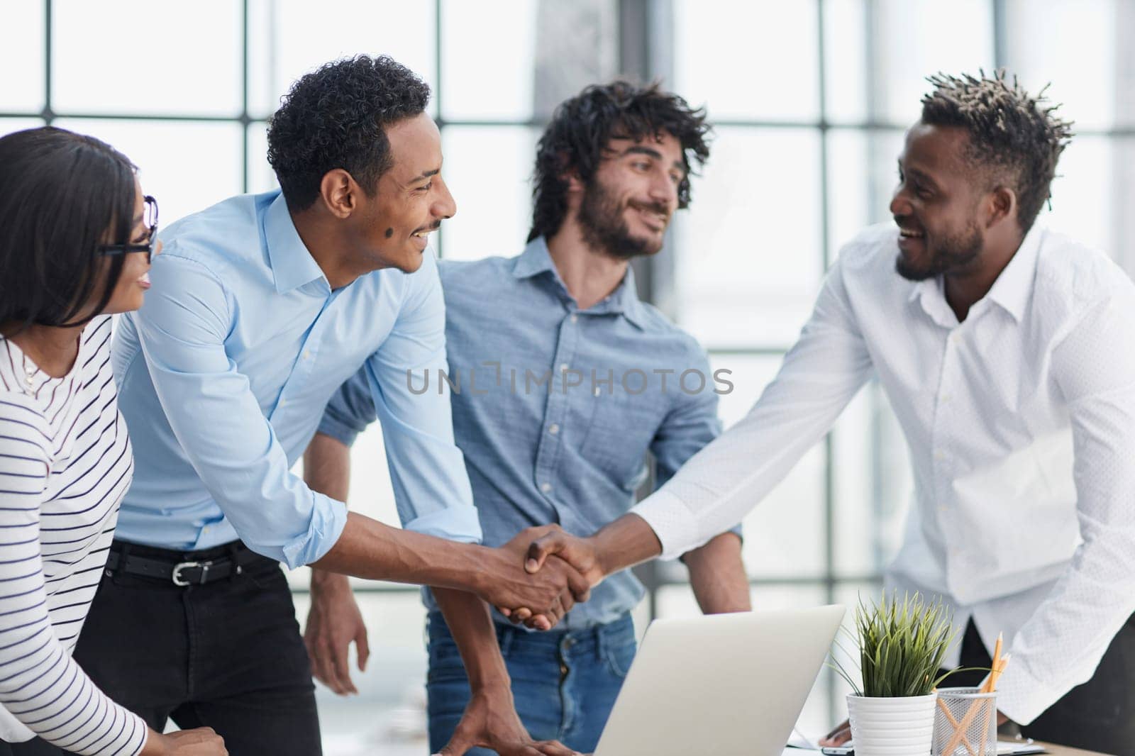 Successful Business Collaboration: Executives Greet with Handshake in Office by Prosto