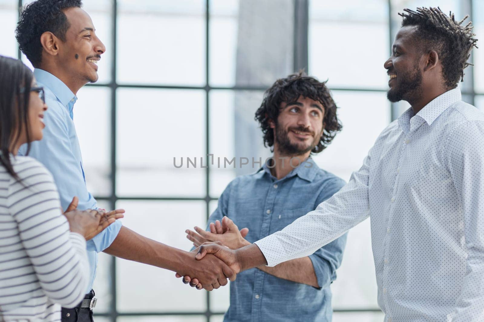 Successful Business Collaboration: Executives Greet with Handshake in Office by Prosto
