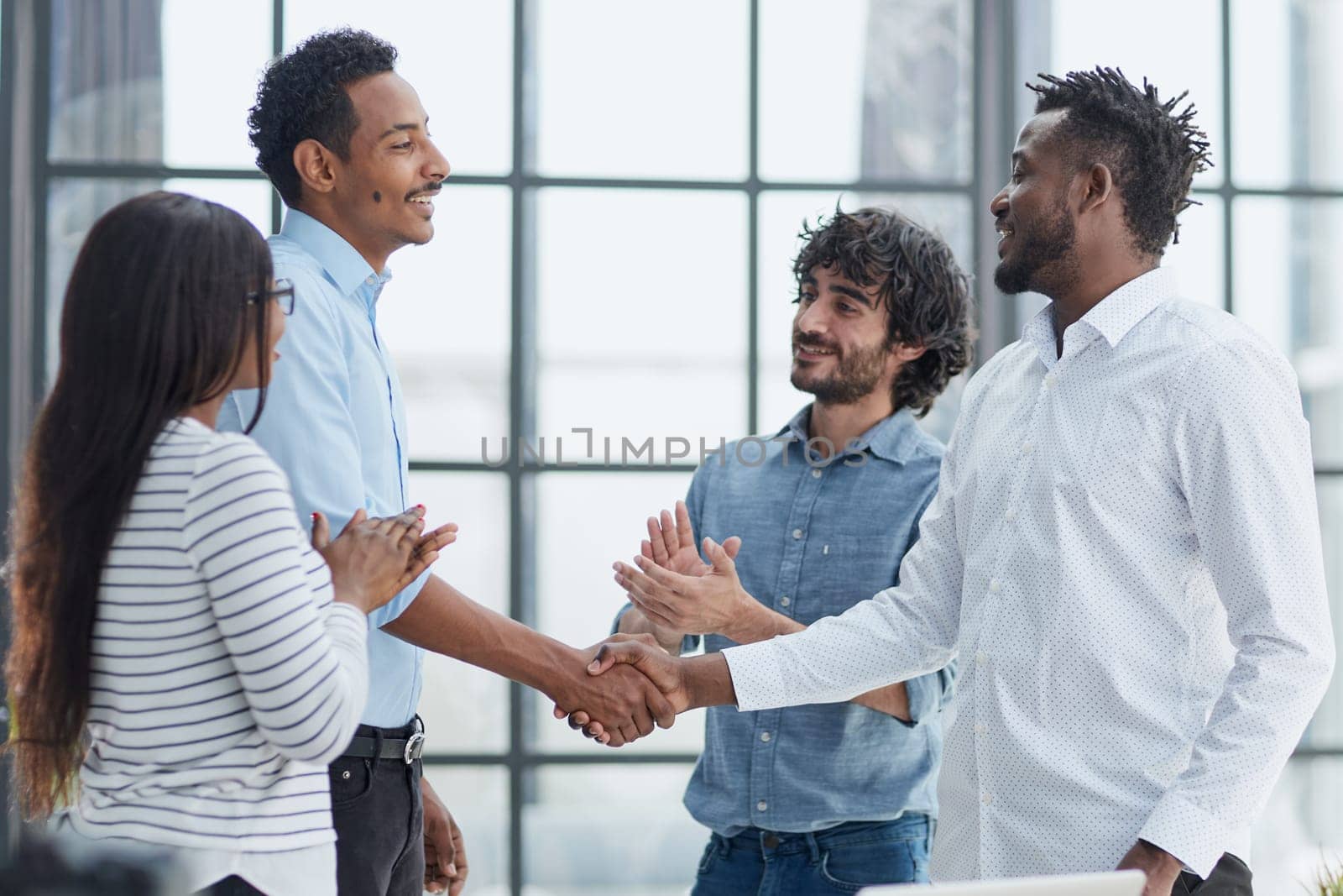 Successful Business Collaboration: Executives Greet with Handshake in Office by Prosto