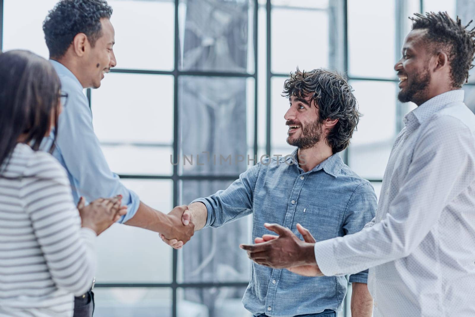 Successful Business Collaboration: Executives Greet with Handshake in Office by Prosto