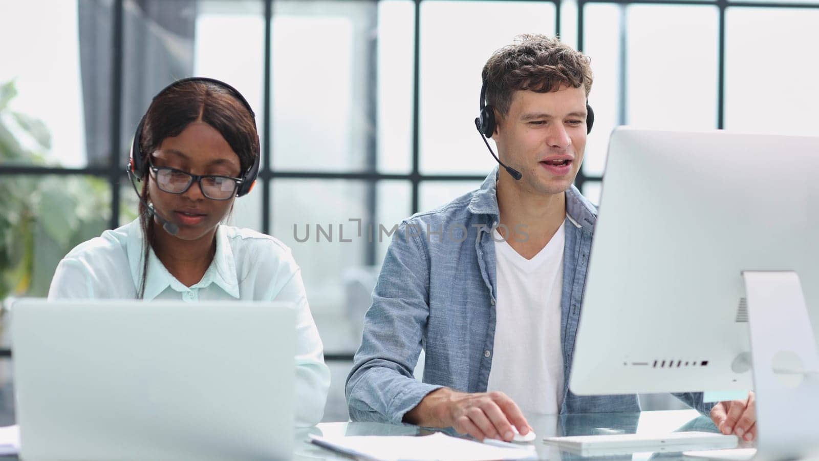 operators woman and man agent with headsets working in a call center.