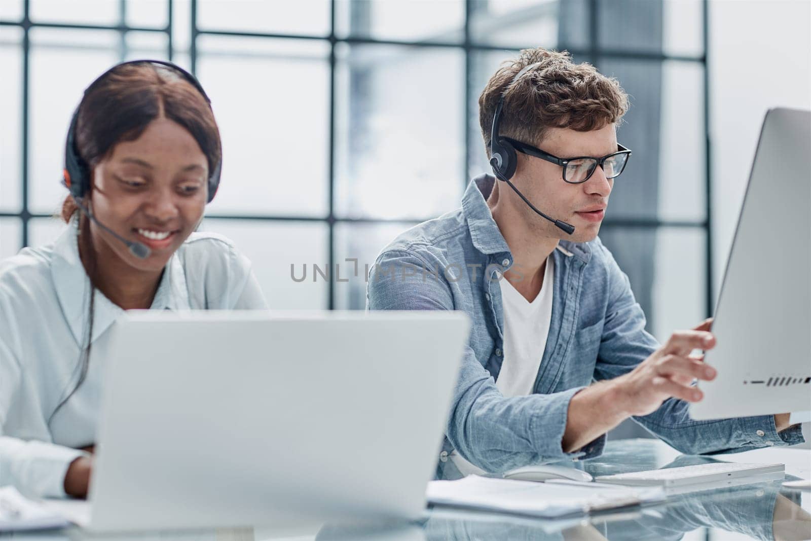 friendly operator woman agent with headsets working in a call center