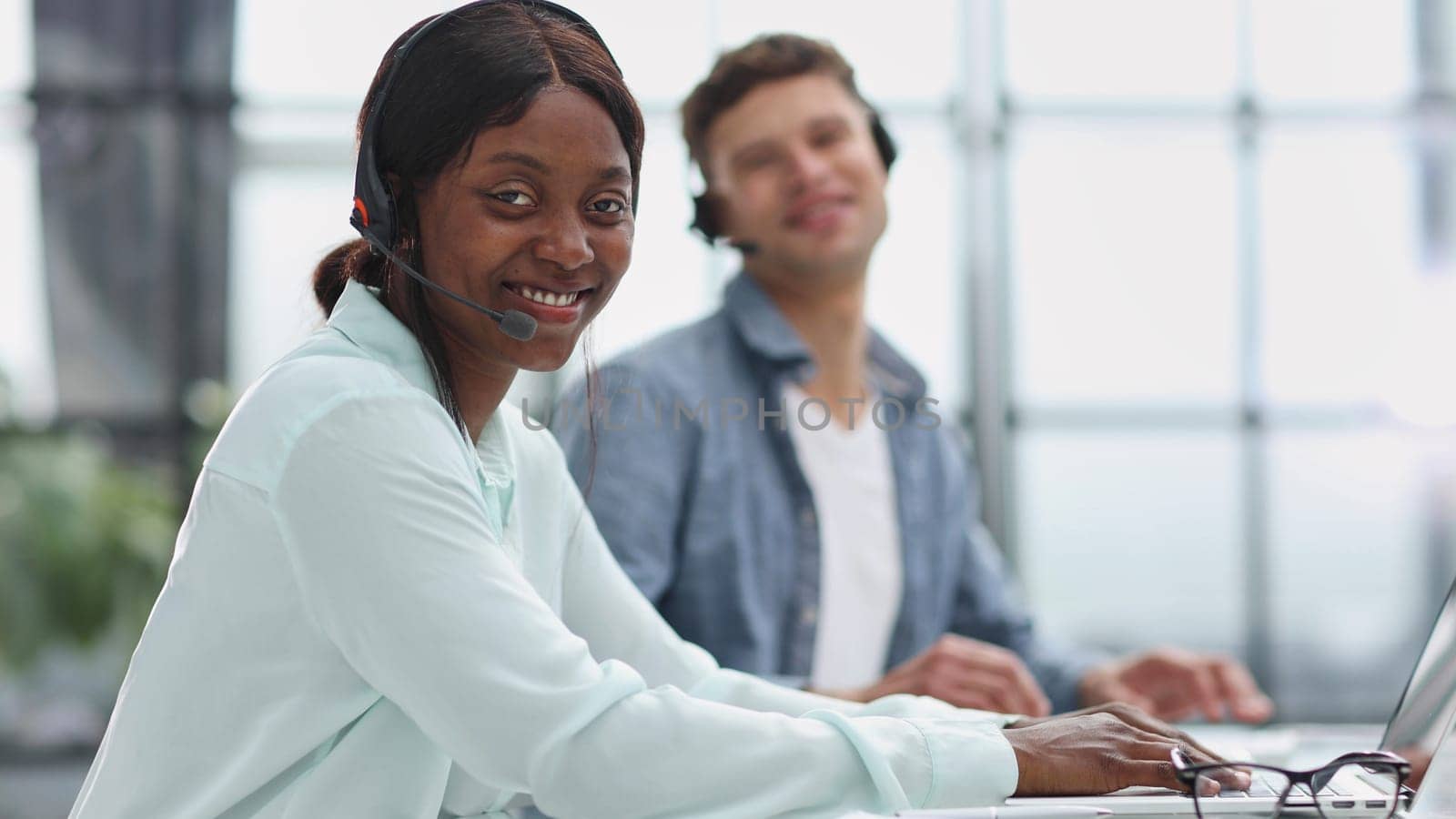 operators woman and man agent with headsets working in a call center.