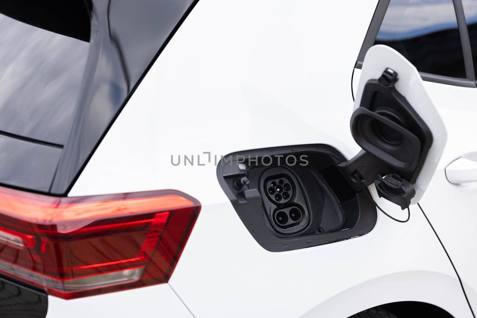 Fast charging socket type 2 combo electric car. Type 2 CCS plug port on electric vehicle. DC - CCS type 2 EV charging connector at EV car. Eco friendly alternative energy green environment concept
