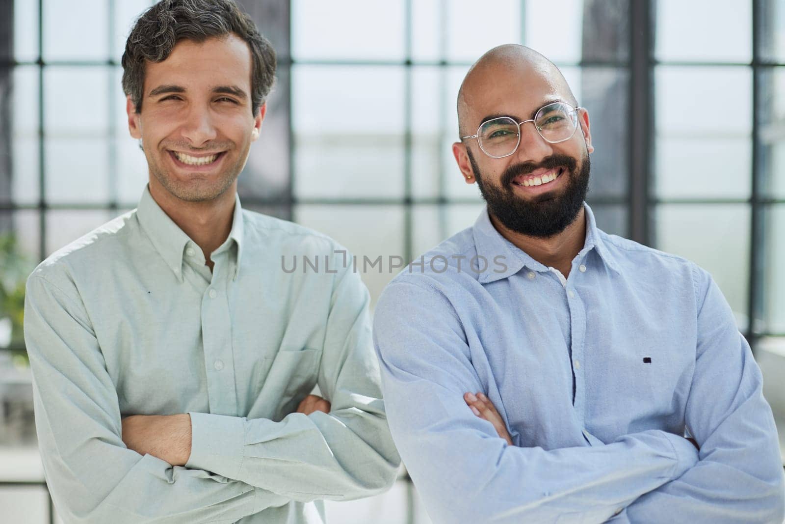 two smiling businessmen in the modern office