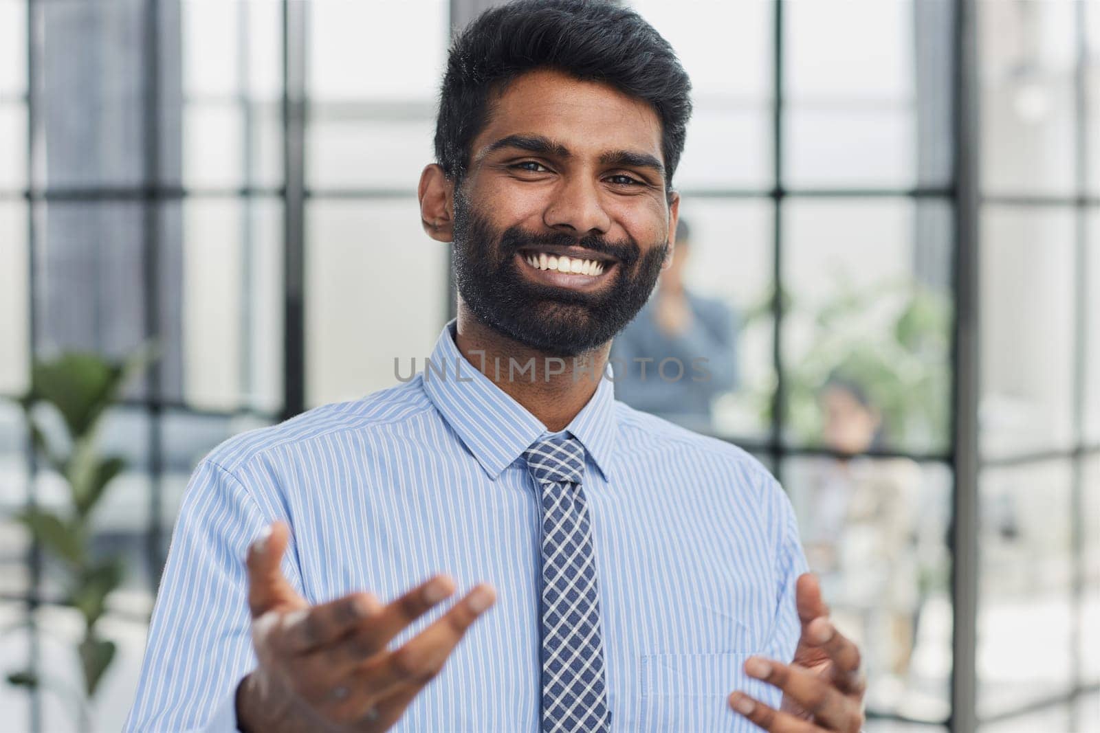 male investor beard looking at camera and smiling in modern office
