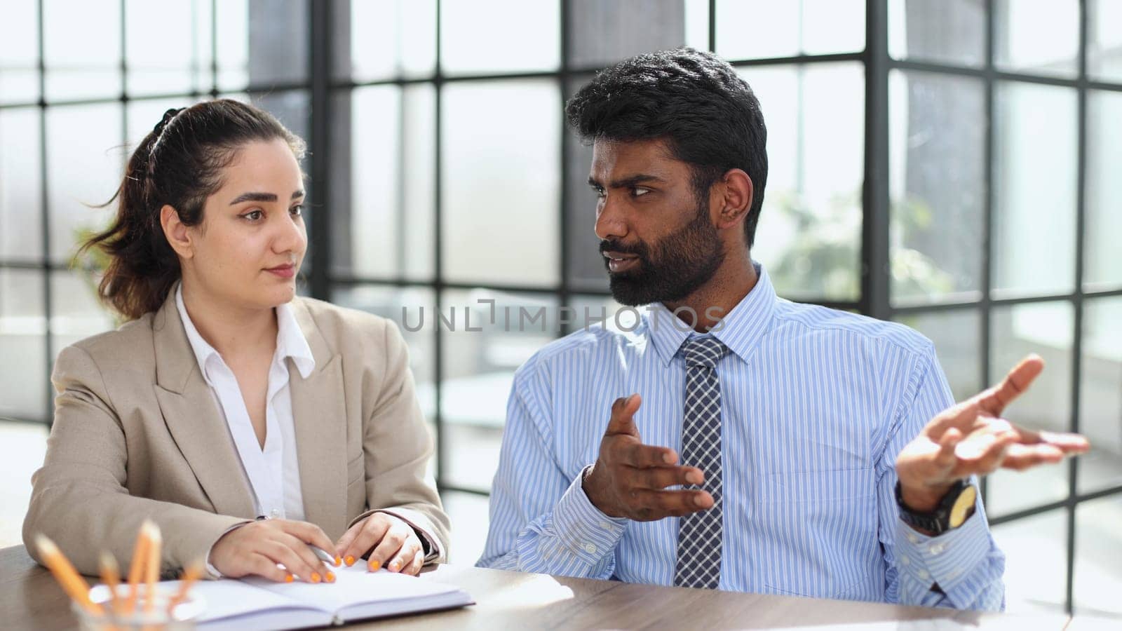 Young indian mentor coach talking with female colleague teaching by Prosto