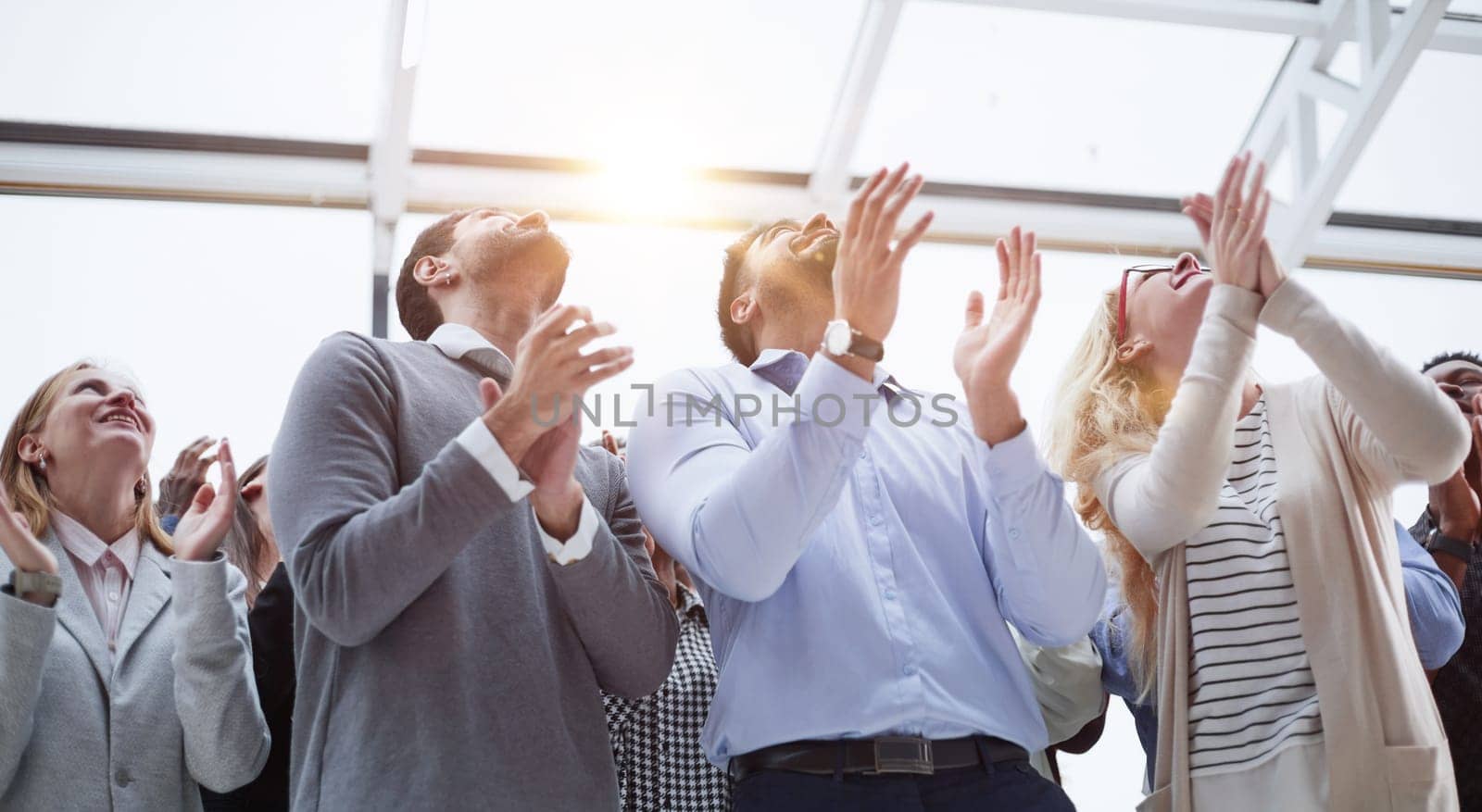 Group of young business people looking up