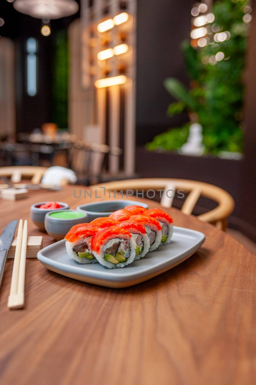 Sushi roll with salmon, shrimp, avocado and cream cheese on a plate. High quality photo