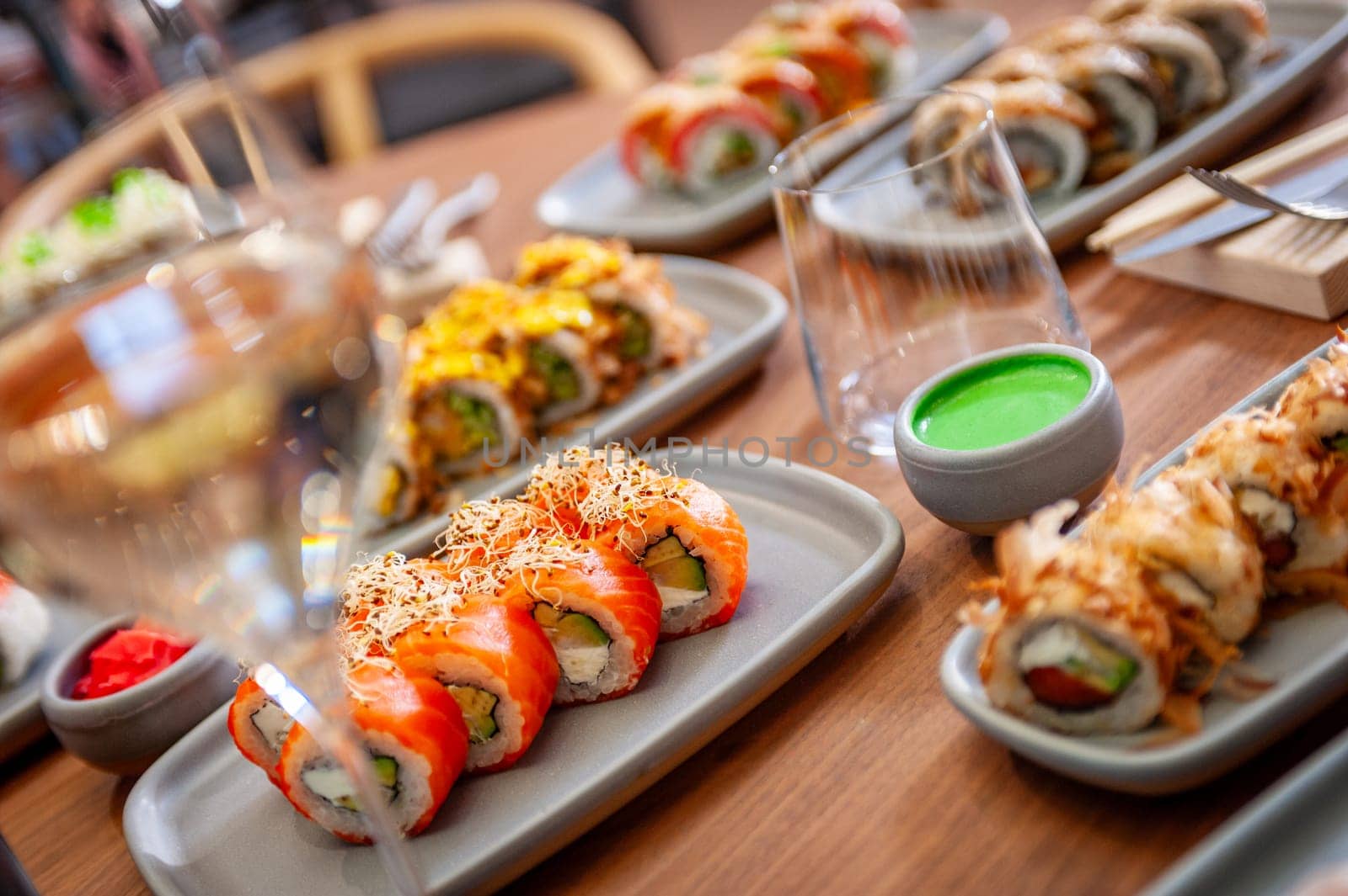 A set of sushi rolls on a table in a restaurant. High quality photo.