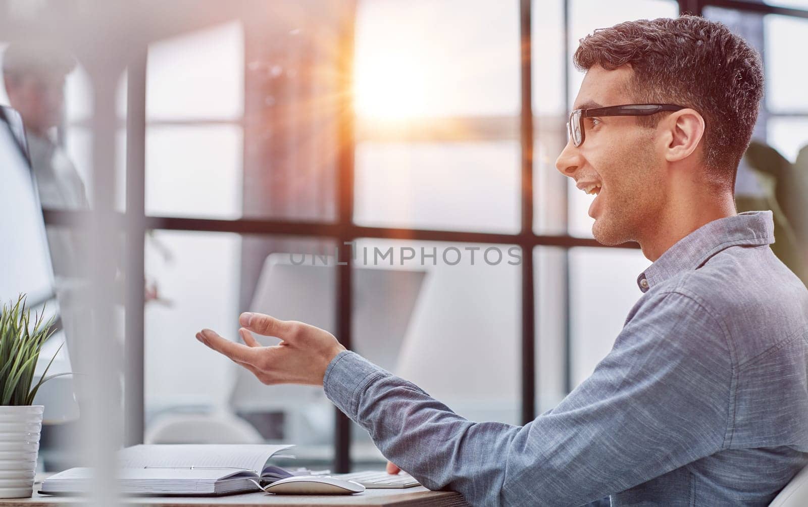 side view of handsome young businessman looking at computer