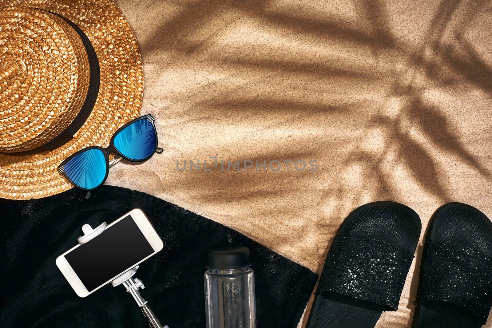 Summer background with straw hat, sunglasses, sunscreen bottle and flip flops. Top view. Still life. Copy space. flat lay