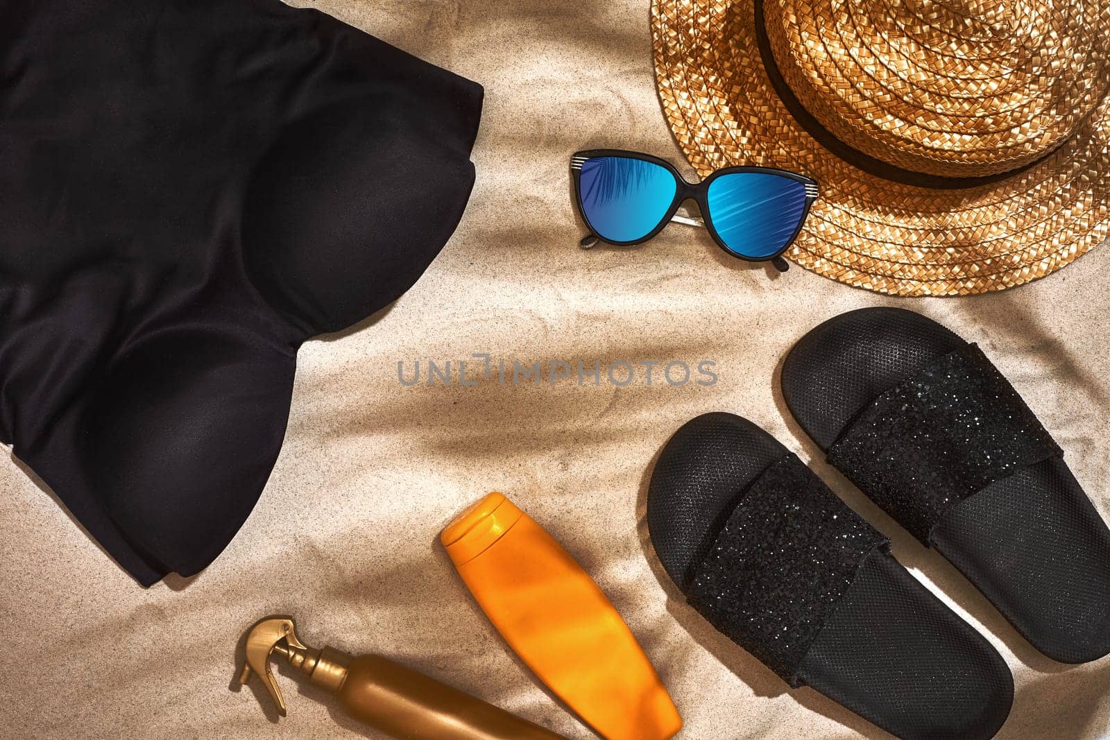 Summer background with straw hat, sunglasses, sunscreen bottle and flip flops. Top view. Still life. Copy space. flat lay