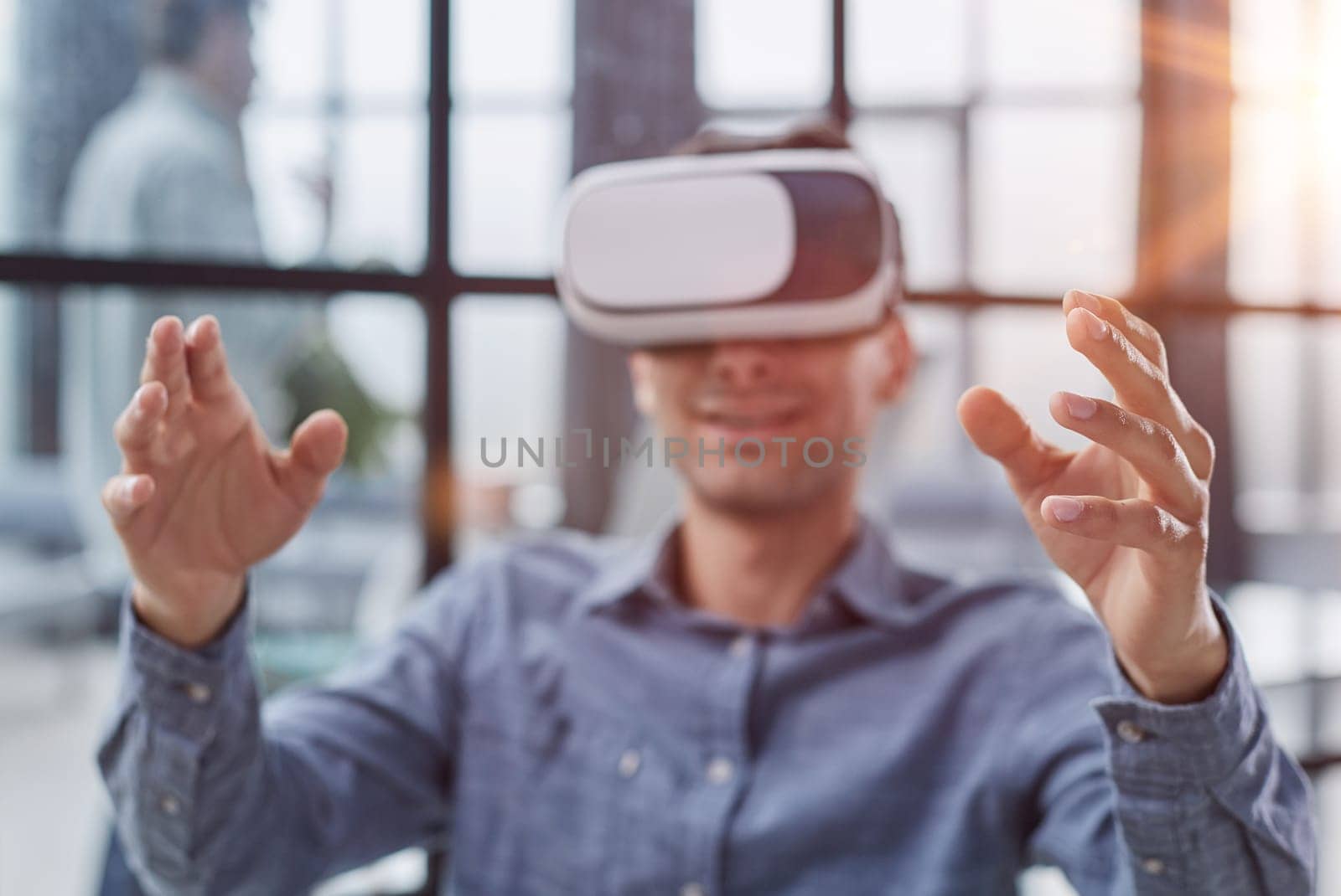 smiling young man using virtual reality headset while sitting in office Generative AI