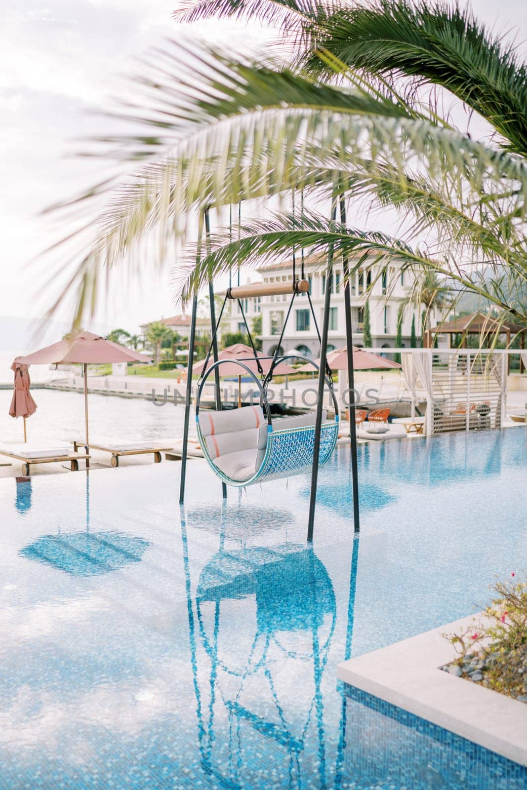 Hanging chair on stands in the pool of a hotel complex. High quality photo