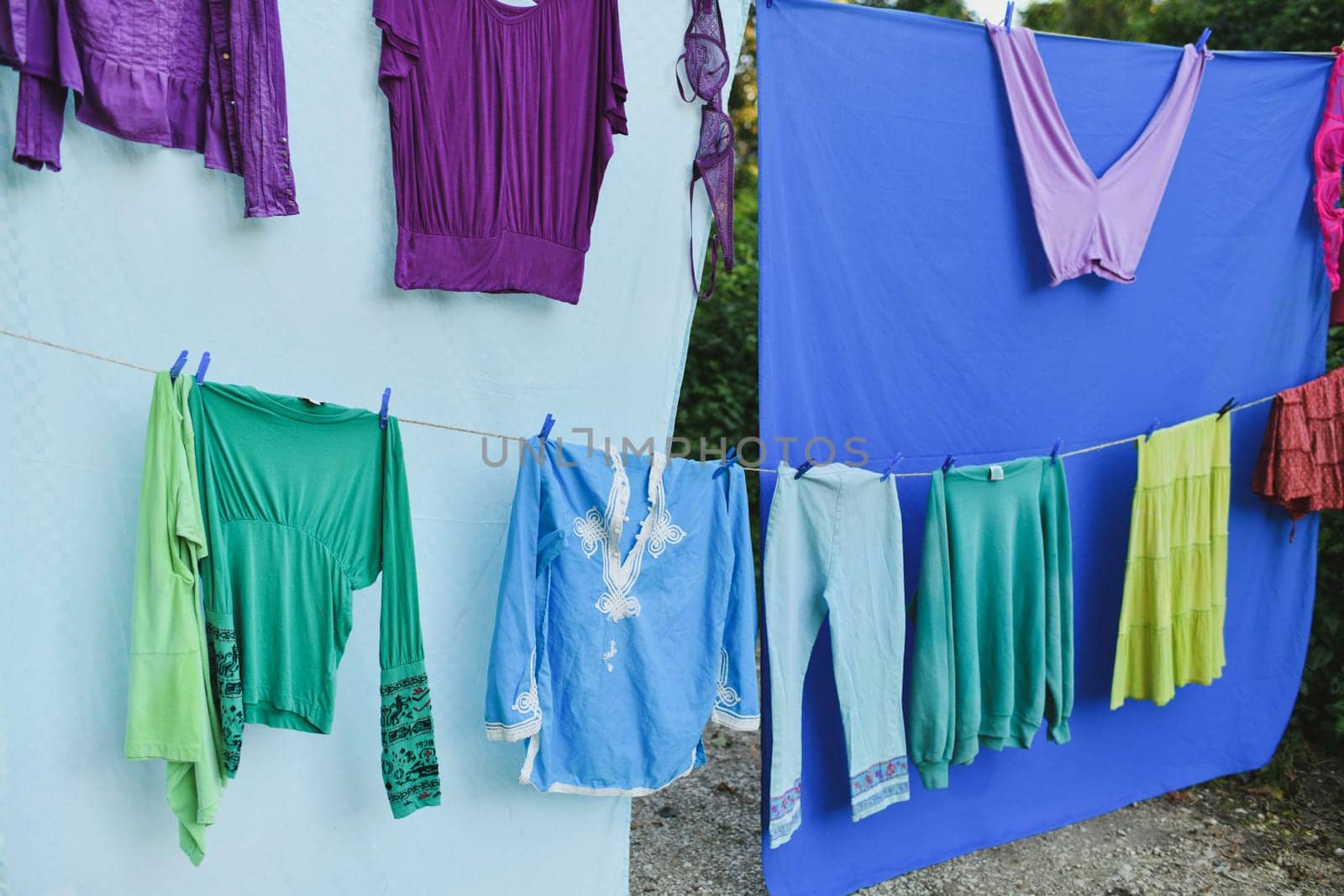 Colored clothes dry in the wind on a rope