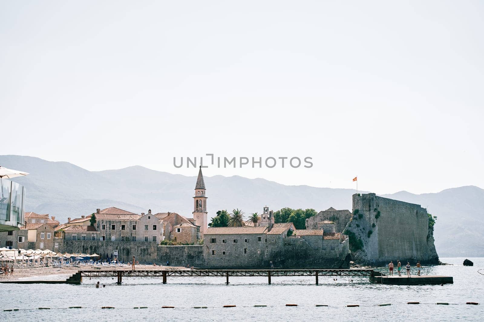 Long pier along the fortress walls of the citadel of the old town of Budva. Montenegro. High quality photo