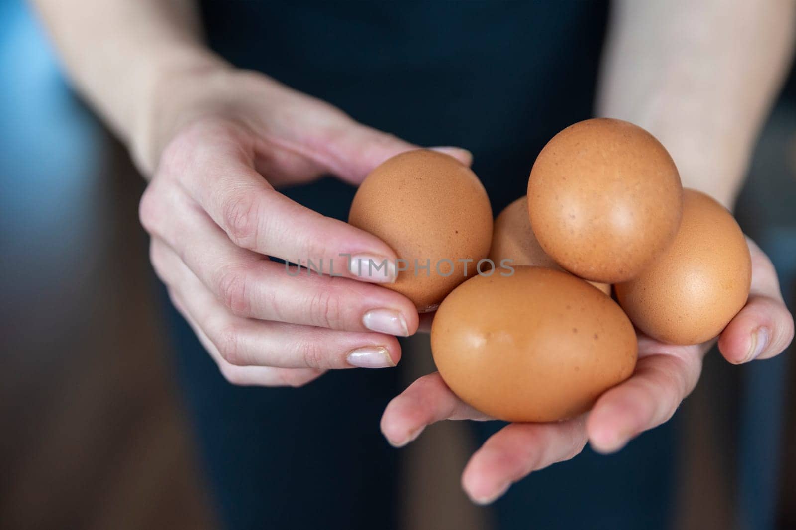 Woman holding chicken eggs close-up. Fresh chicken eggs will be served to the guests. High quality photo