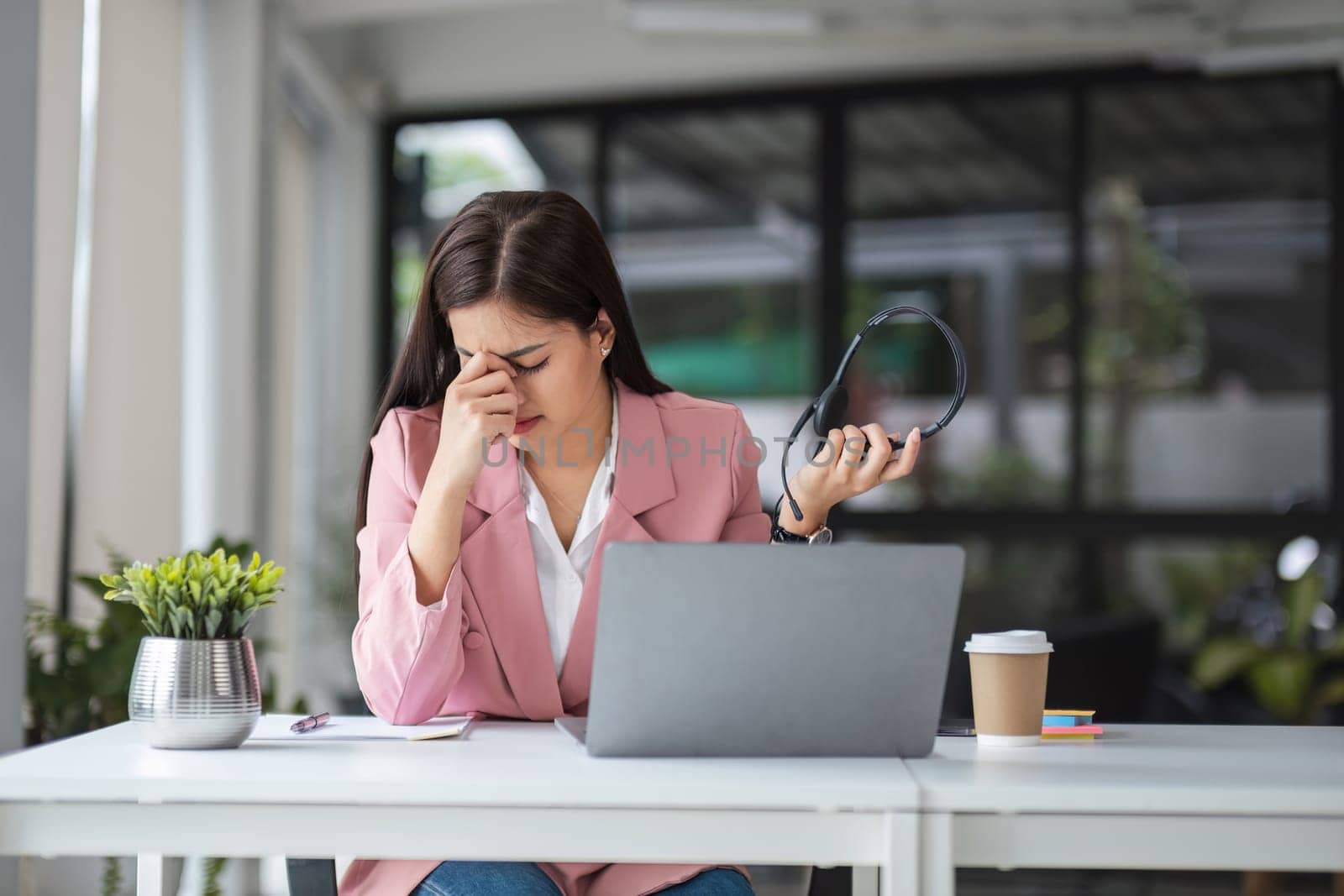 The call center operator is exhausted while explaining job details to customers on their laptops..