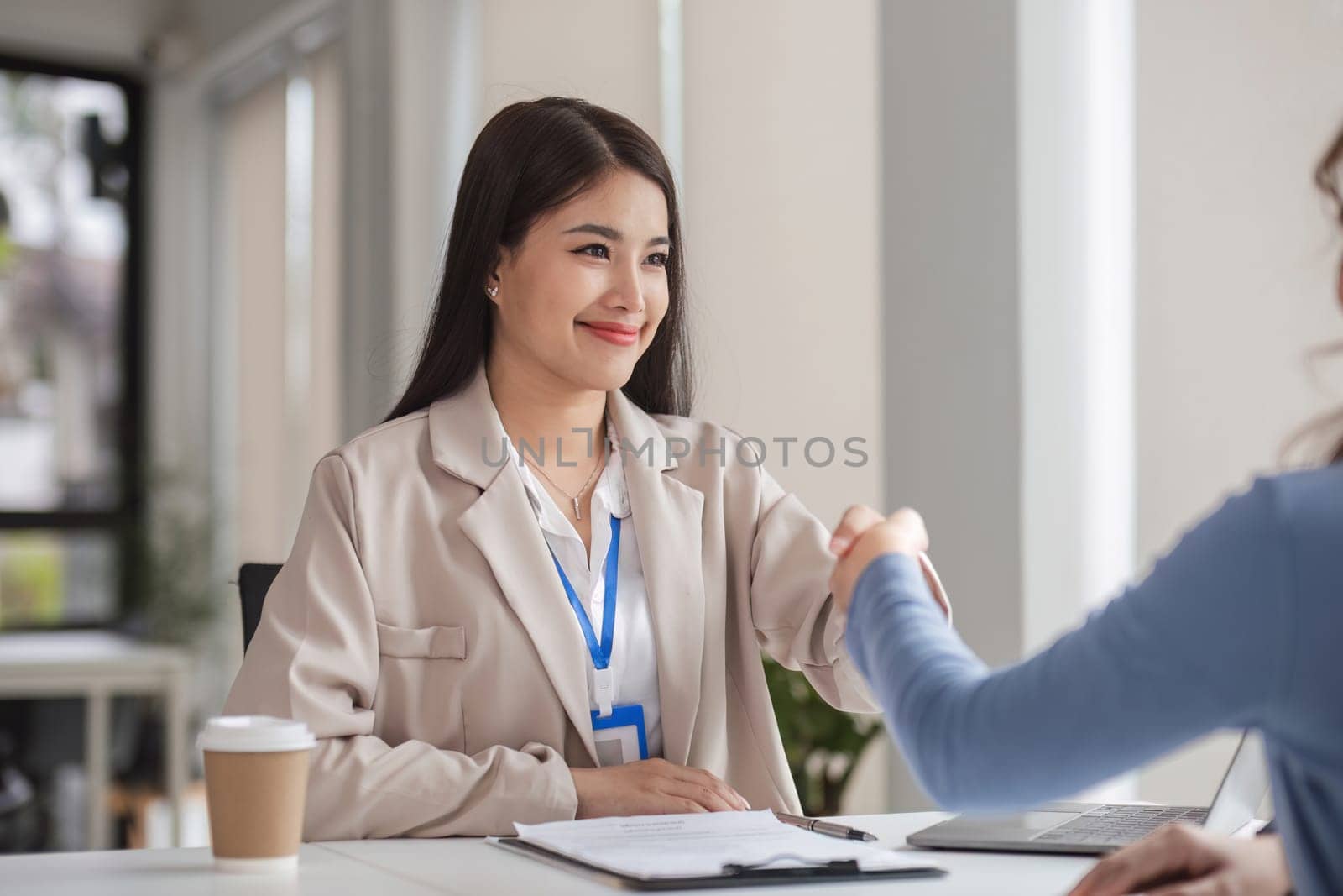 Young businesswoman discussing an offer of a collaboration and a successful deal. by wichayada