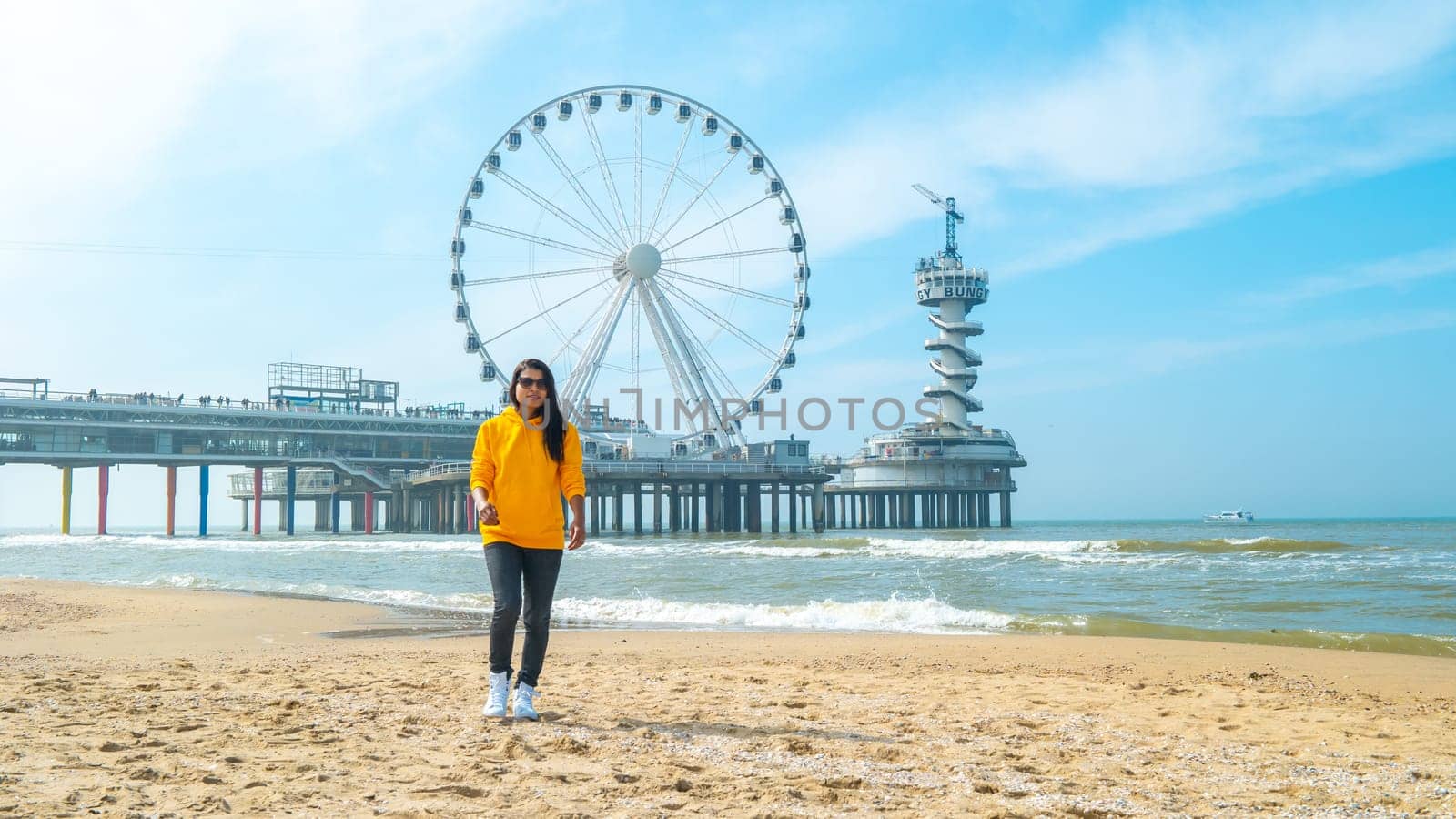 women on the beach of Scheveningen Netherlands during Spring, The Ferris Wheel at The Pier at Scheveningen in the Netherlands