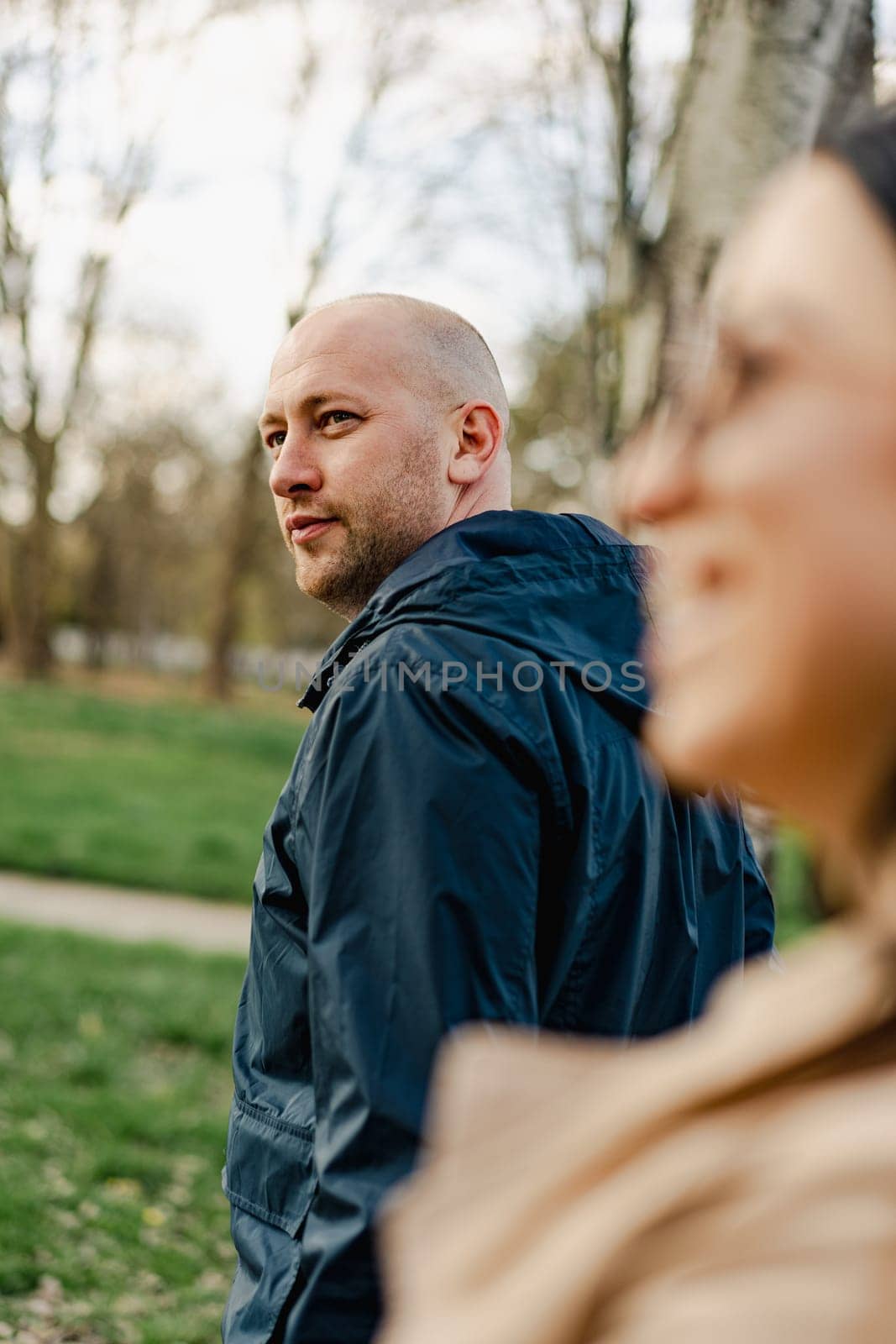 Happy couple on a walk in the park on autumn day close up by Fabrikasimf