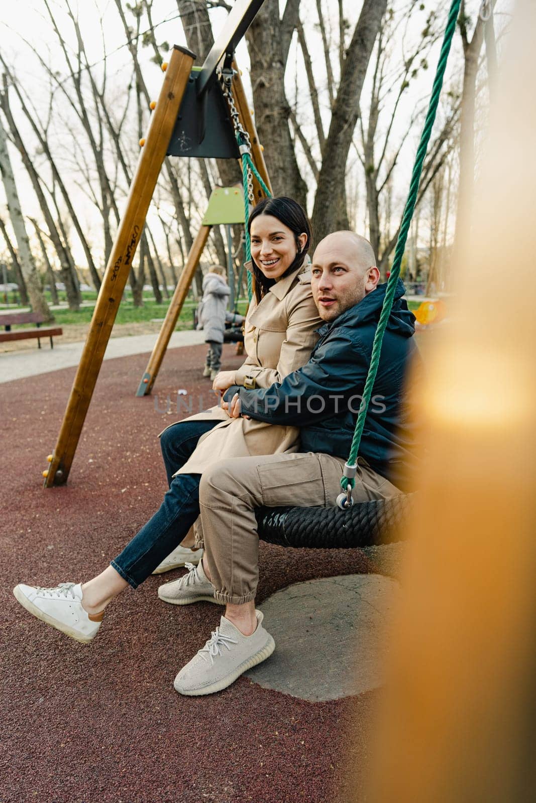Happy smiling couple spend time on a playground in the city