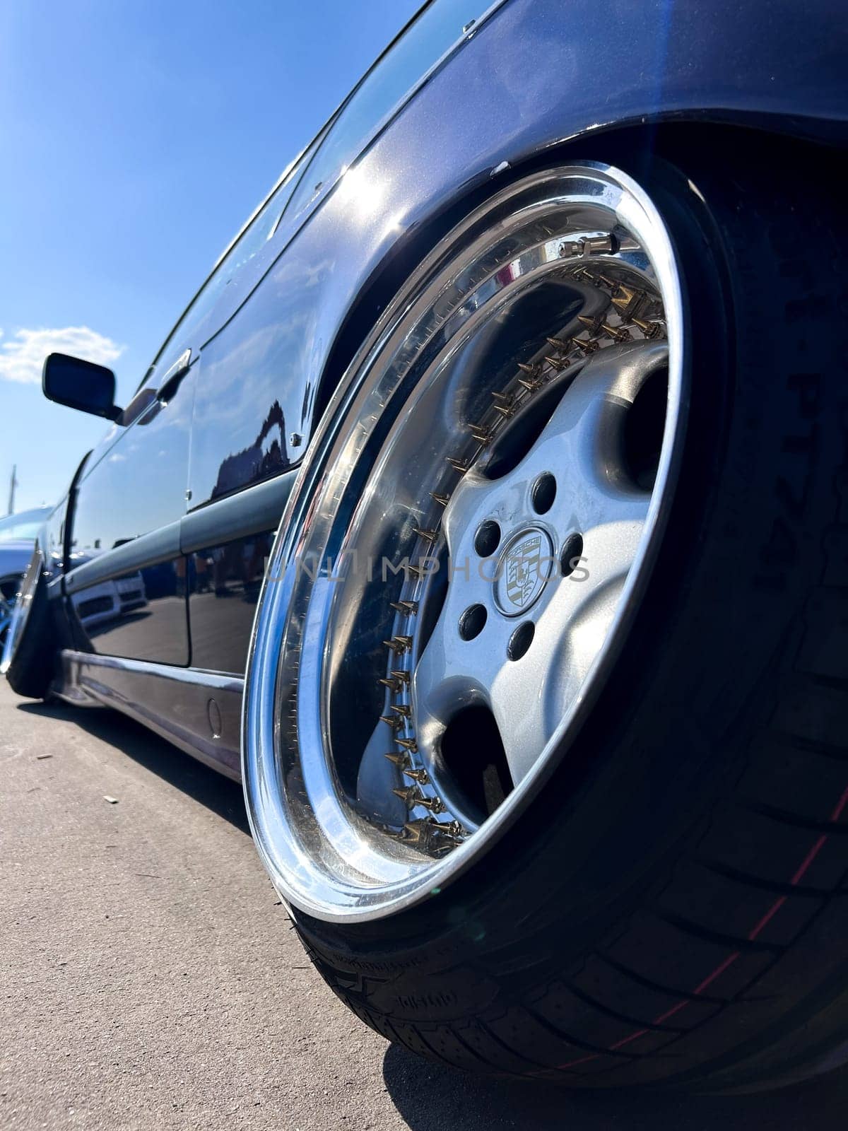 Black car silver Porsche disk wheel close up. High quality photo