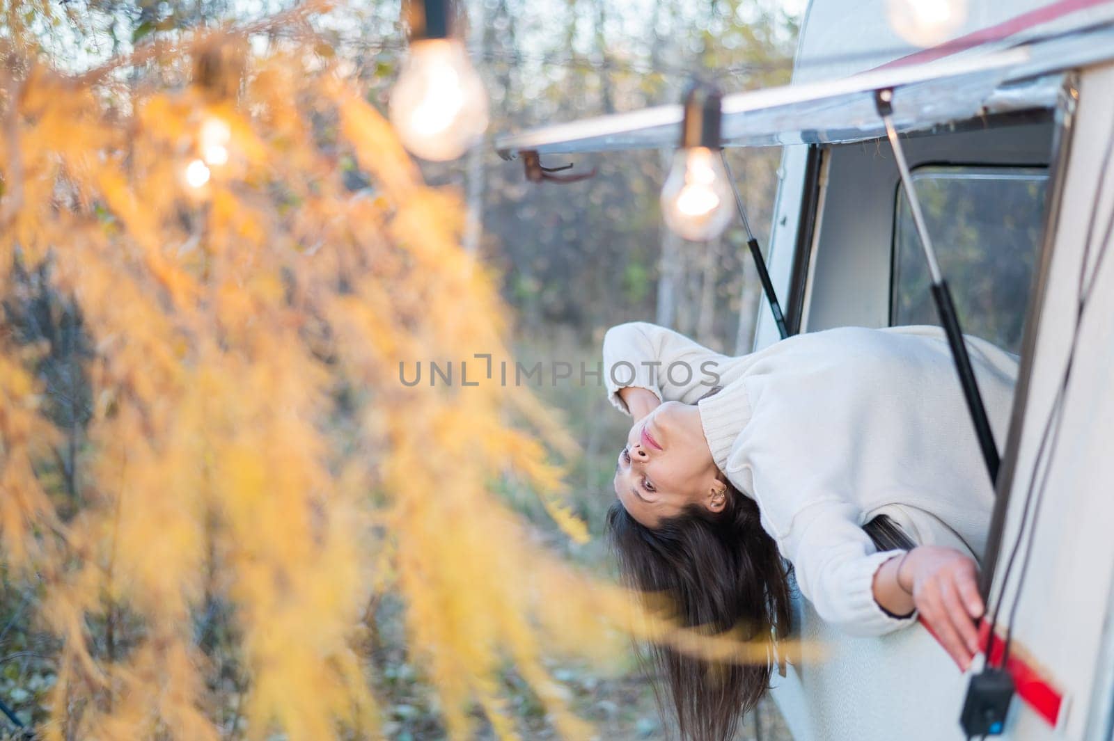 Caucasian woman peeking out of camper window