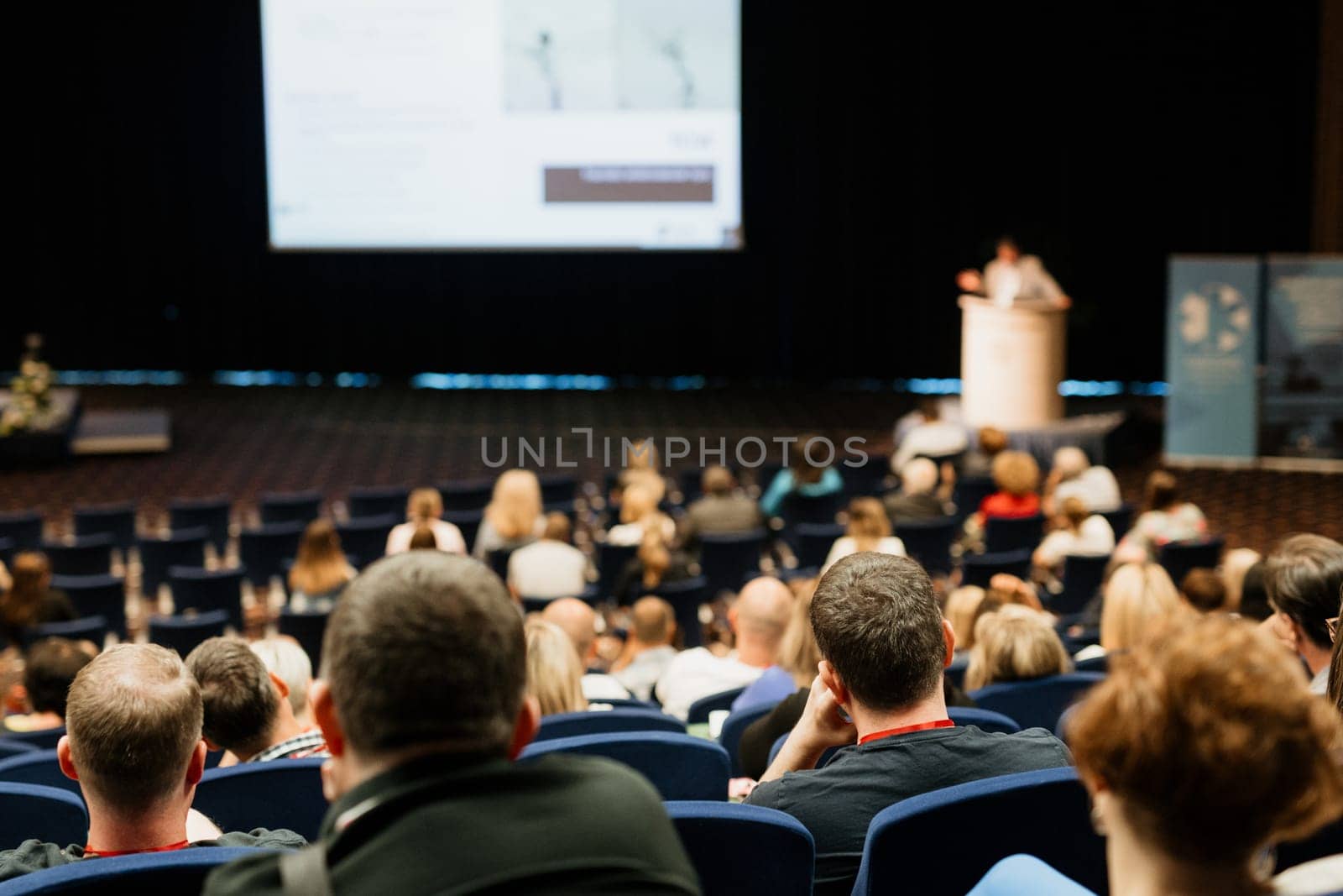 Speaker giving a talk on scientific conference. Audience at the conference hall. Business and Entrepreneurship concept