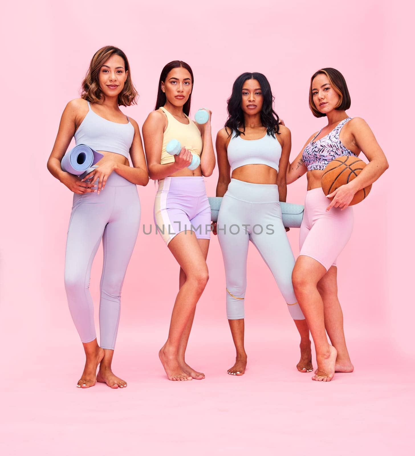 Sports, fitness and portrait of women on pink background for yoga, training and exercise in studio. Friends, team and people with gym equipment, ball and weights for wellness, workout or healthy body.