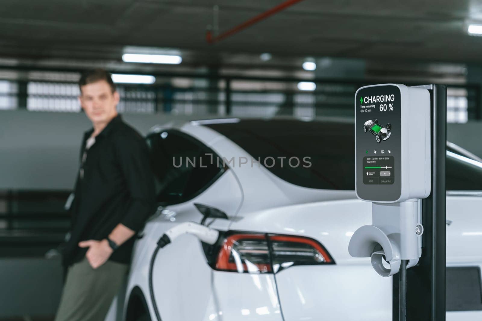 Young man travel with EV electric car to shopping center parking lot charging in downtown city showing urban sustainability lifestyle by green clean rechargeable energy of electric vehicle innards