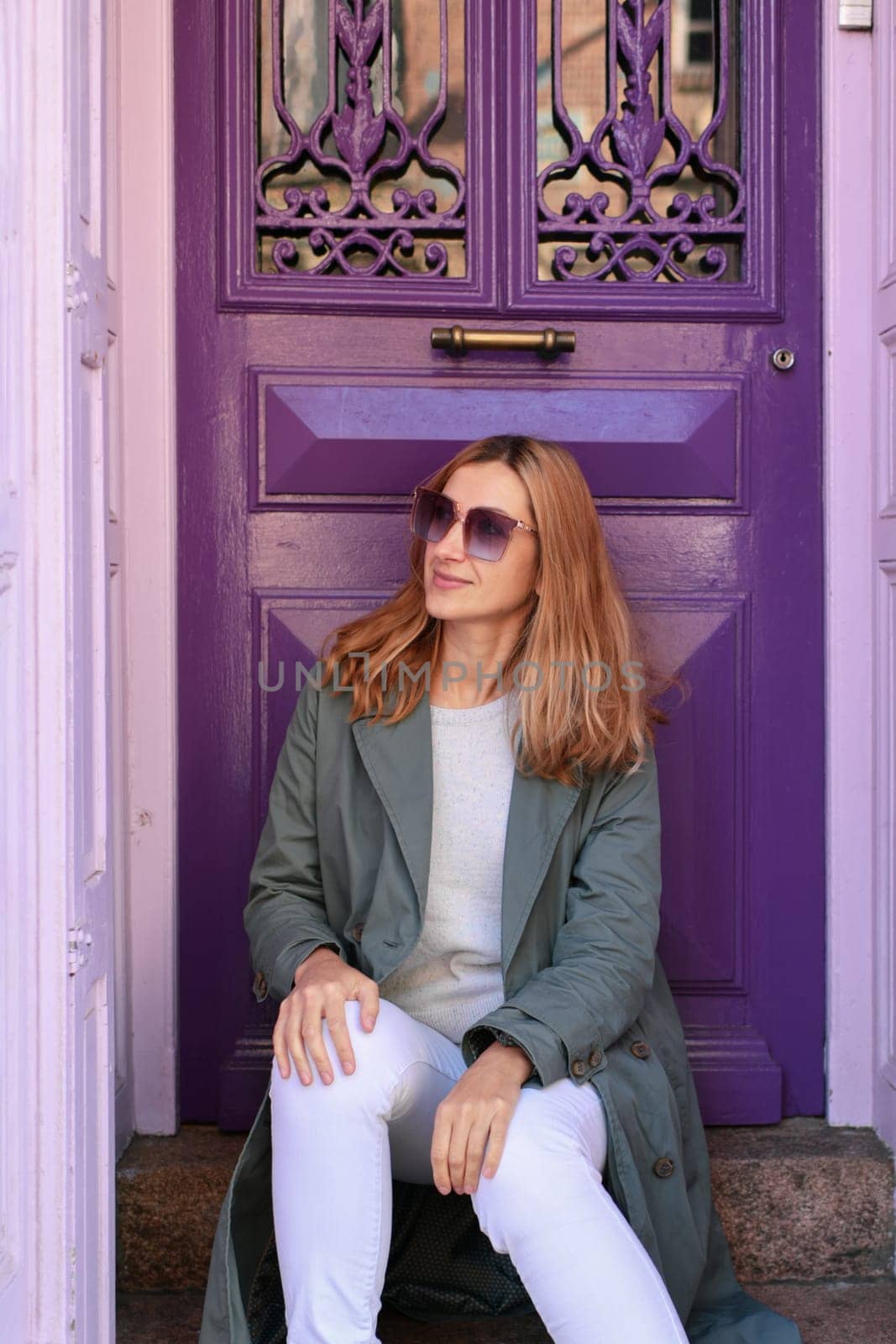 Young woman near purple door