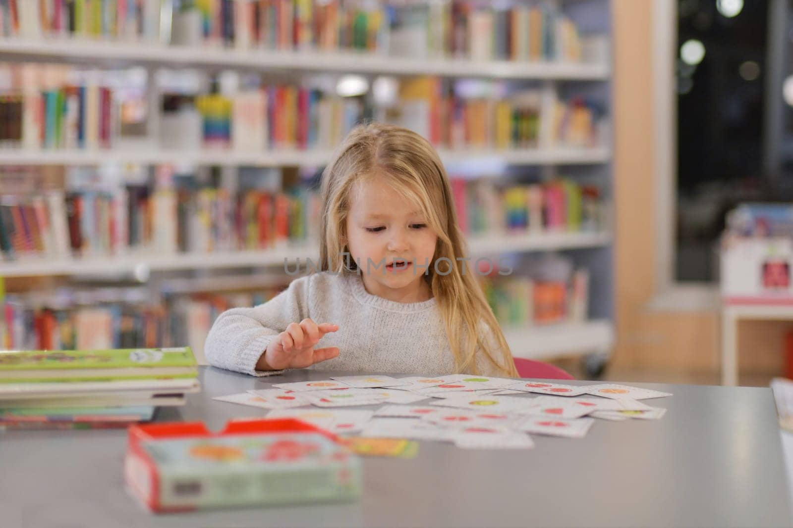Girl plays games in a library