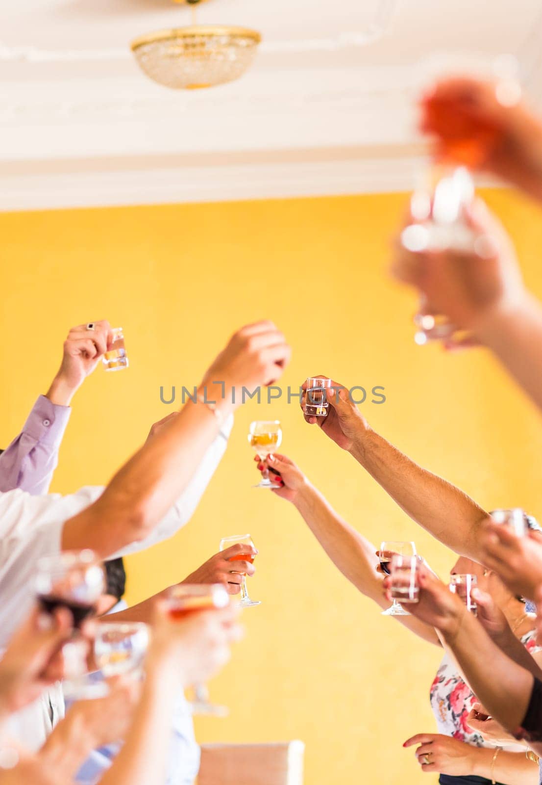 Celebration. Hands holding the glasses of champagne and wine making a toast.
