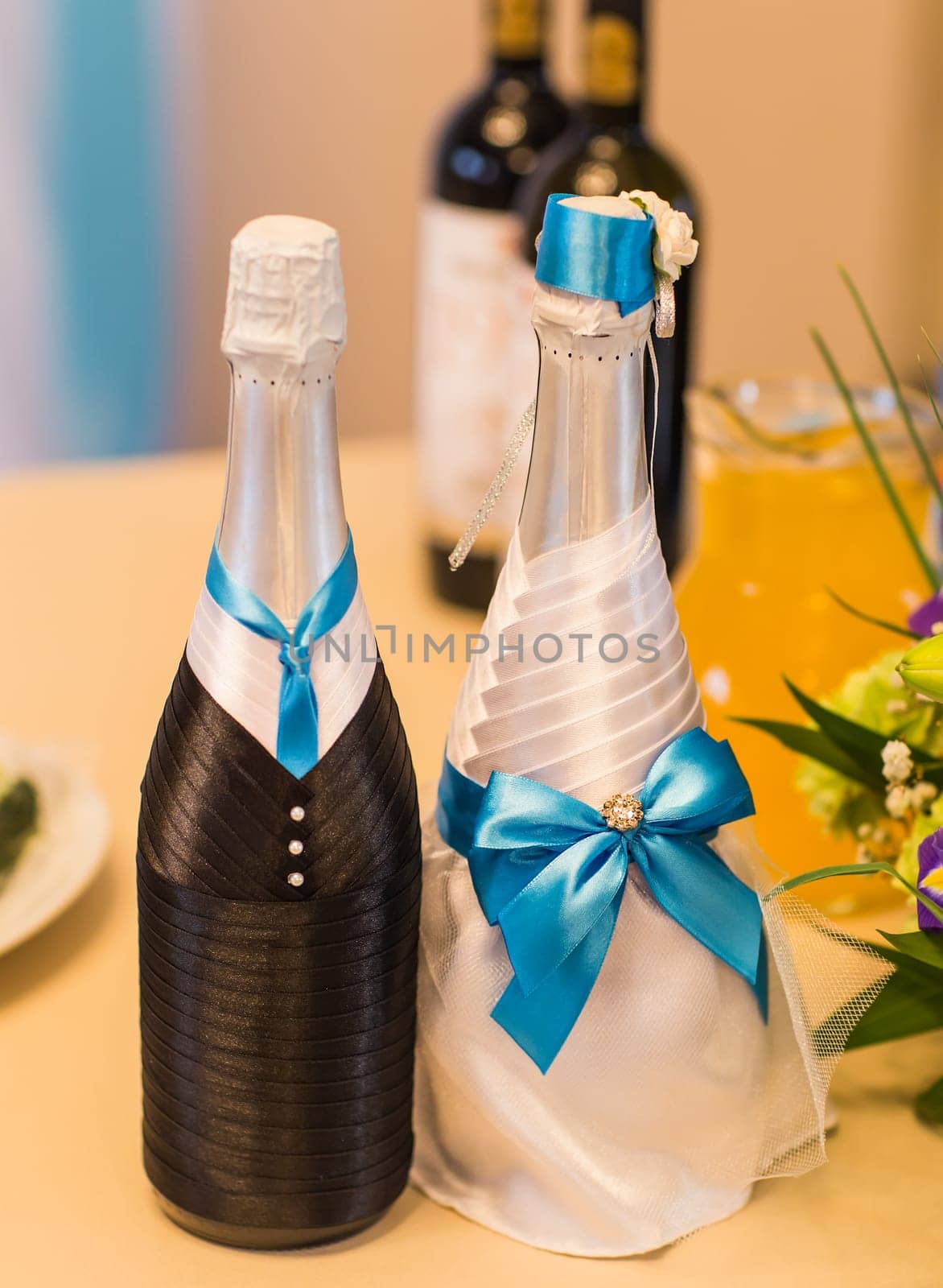 Decorated wedding bottle of champagne. Wedding reception