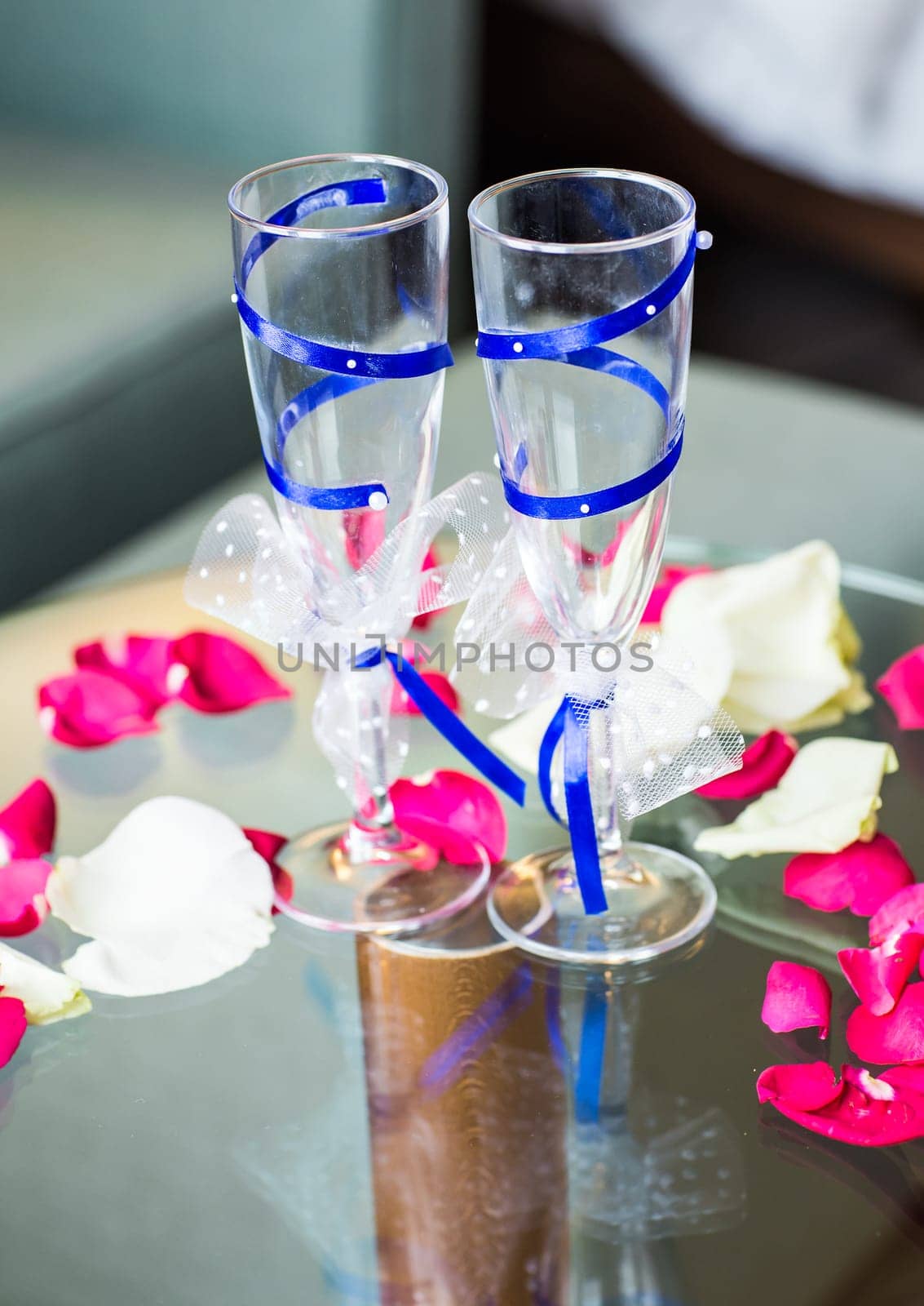 Close-up of wedding decorated champagne glasses on the table by Satura86