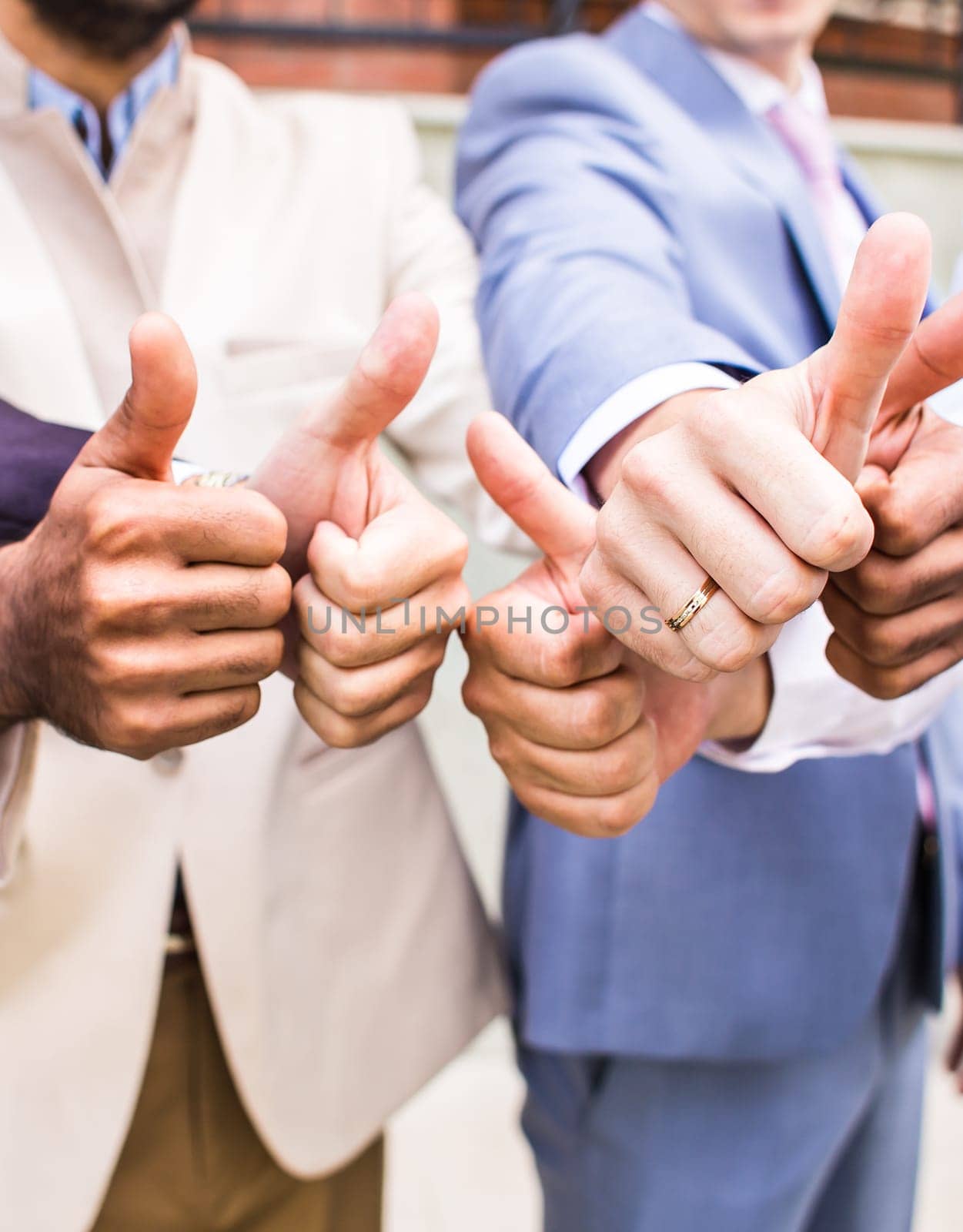 cheerful business group giving thumbs up by Satura86