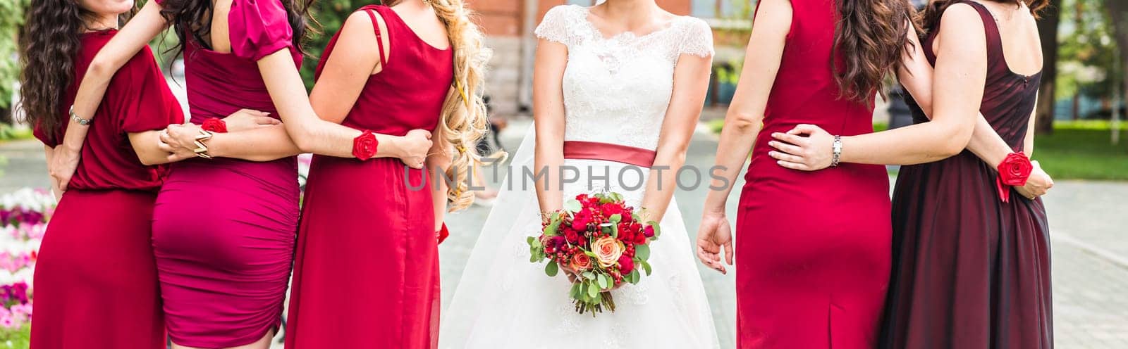 Bride and bridesmaids hand with beautiful flowers.