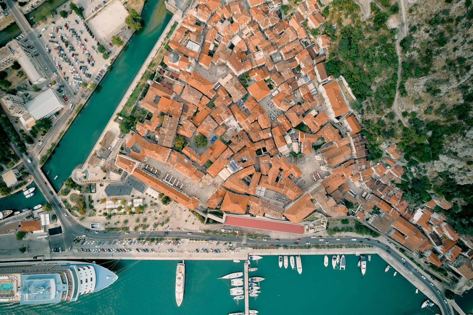Port with moored yachts and a huge cruise ship. Kotor, Montenegro. Top view. High quality photo