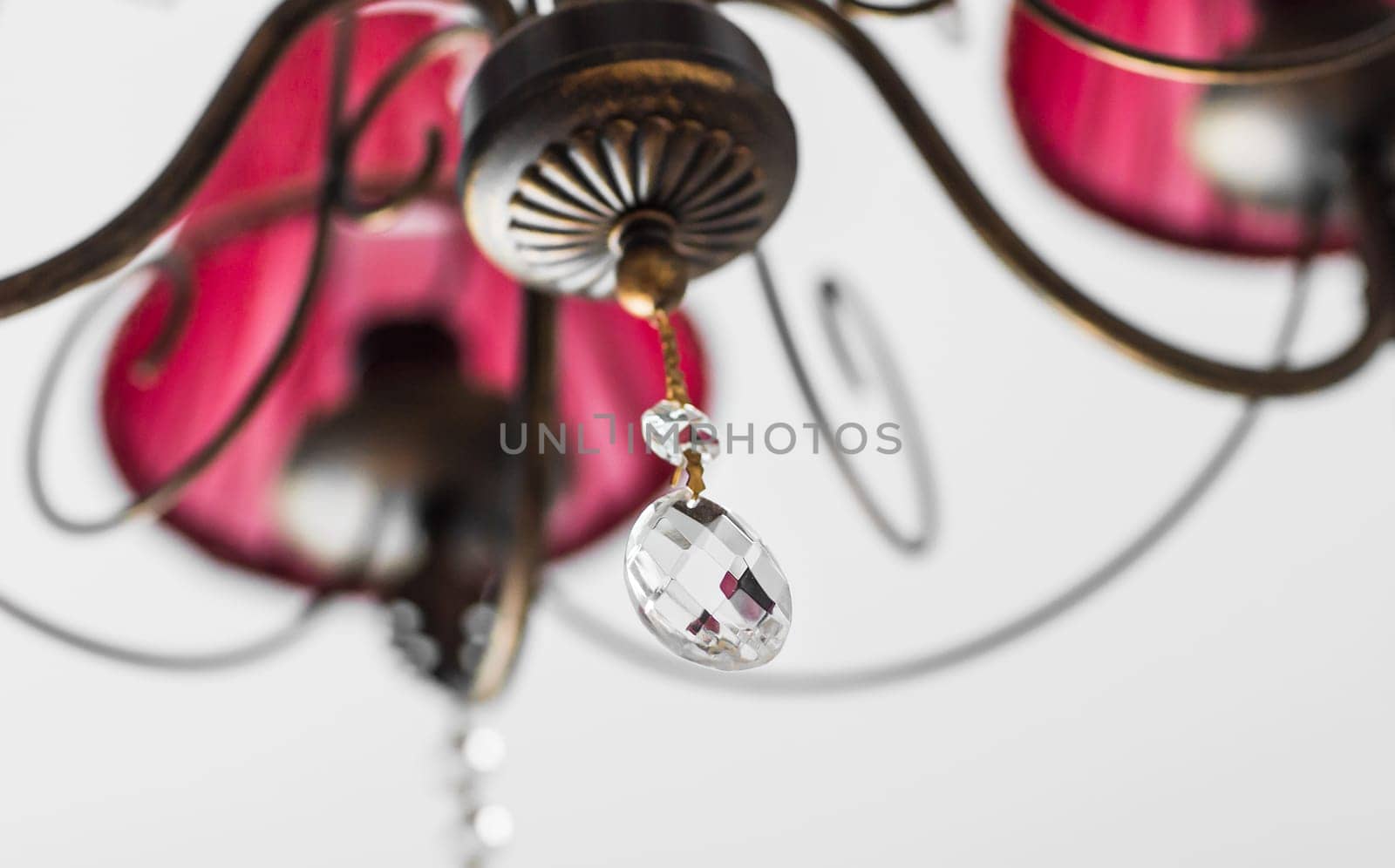 Close-up of a beautiful red chandelier. beautiful crystal chandelier in a room