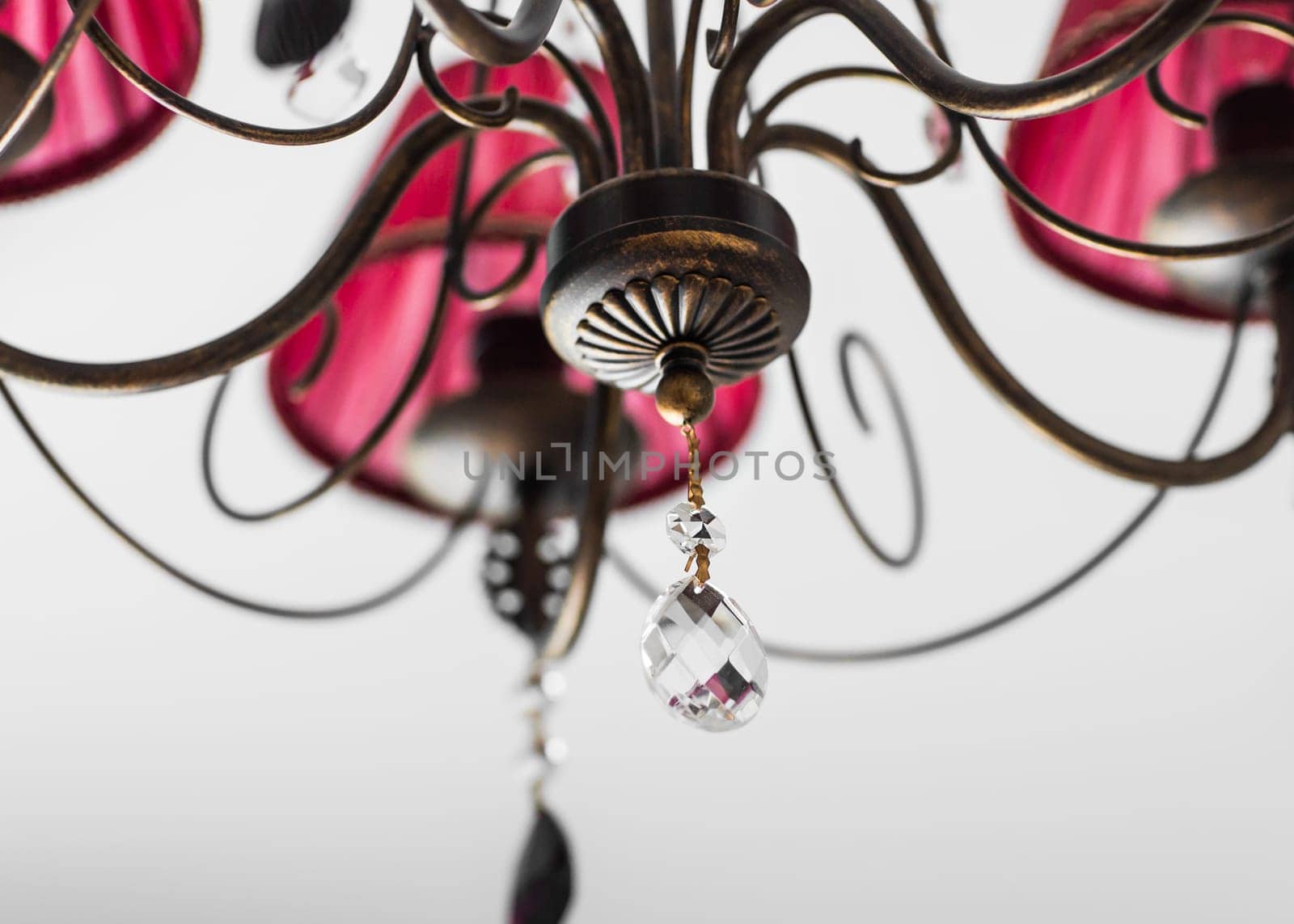 Close-up of a beautiful red chandelier. beautiful crystal chandelier in a room