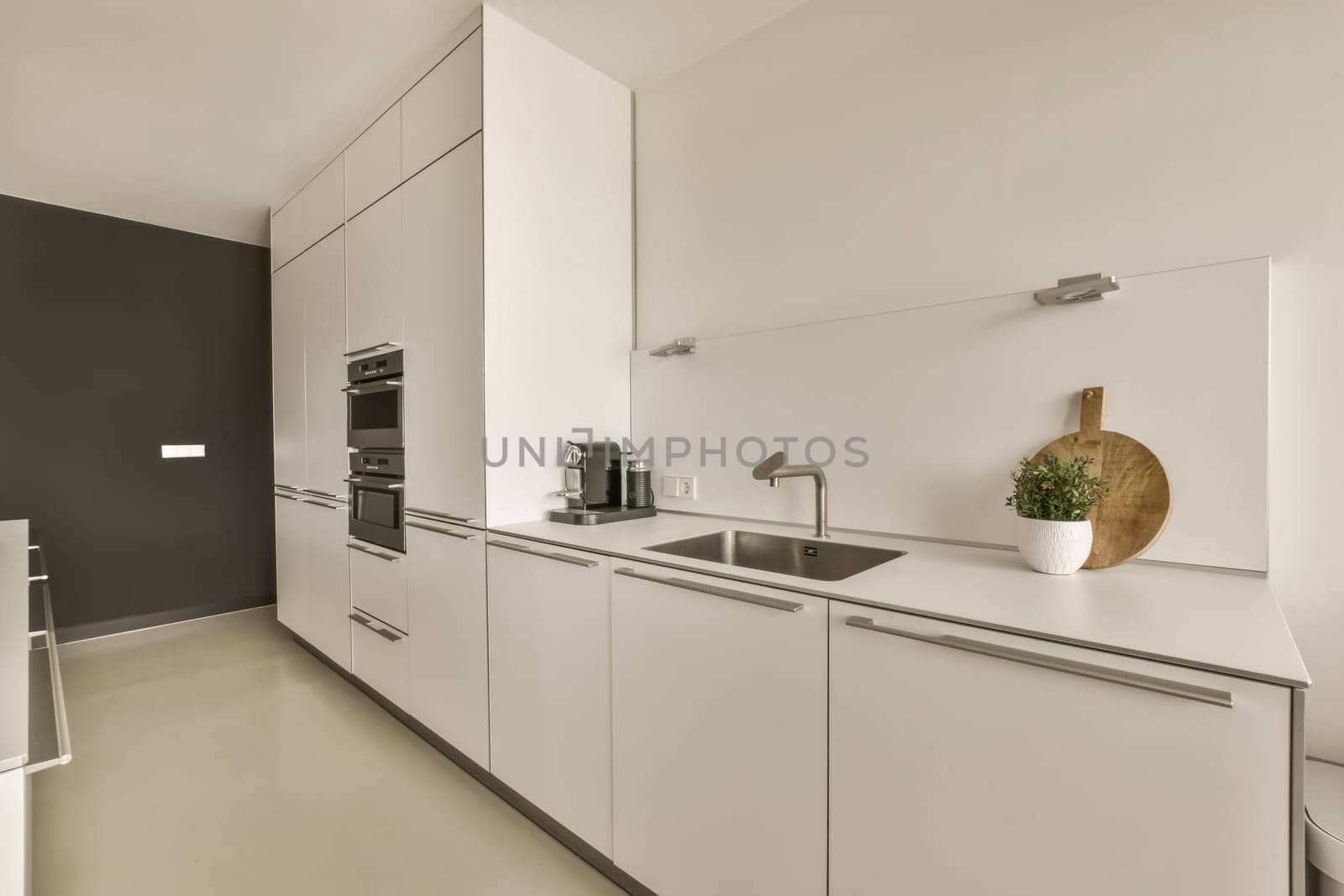a kitchen with white cabinets and a sink by casamedia