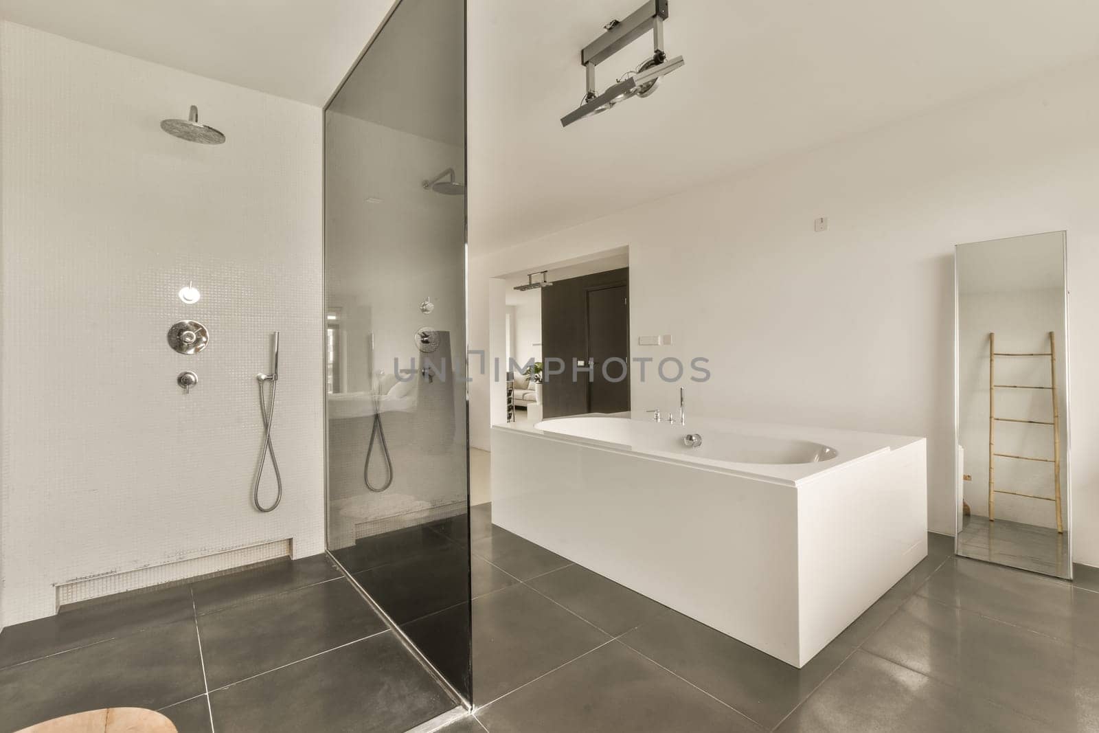 a bathroom with a tub and a shower and a by casamedia