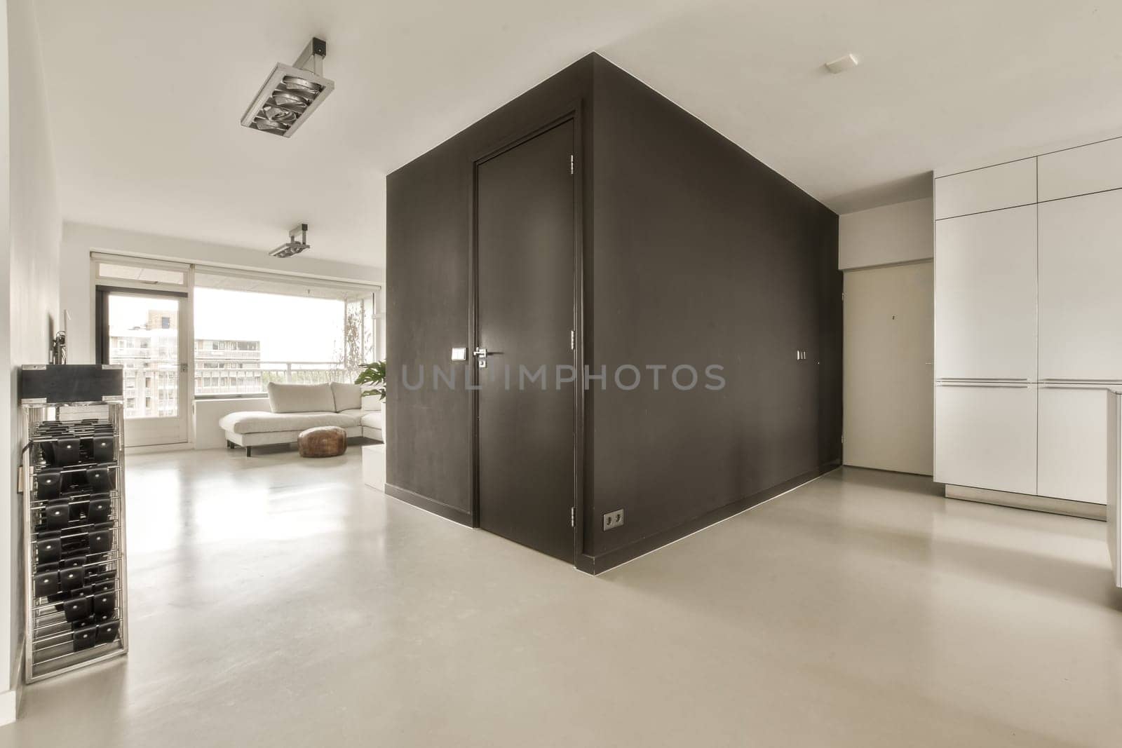a large black wardrobe in a living room with white by casamedia